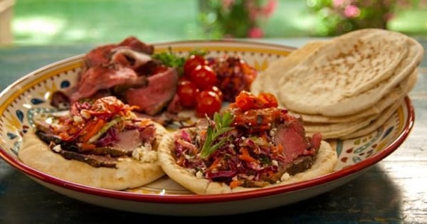 Open-Faced Pitas with Rotisserie Lamb with Pomegranate and Mint, Grilled Tomatoes, and Greek Slaw