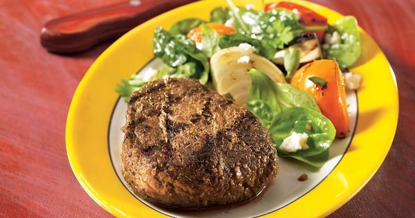 Pesto and garlic blossom venison medallions with grilled vegetable and feta salad