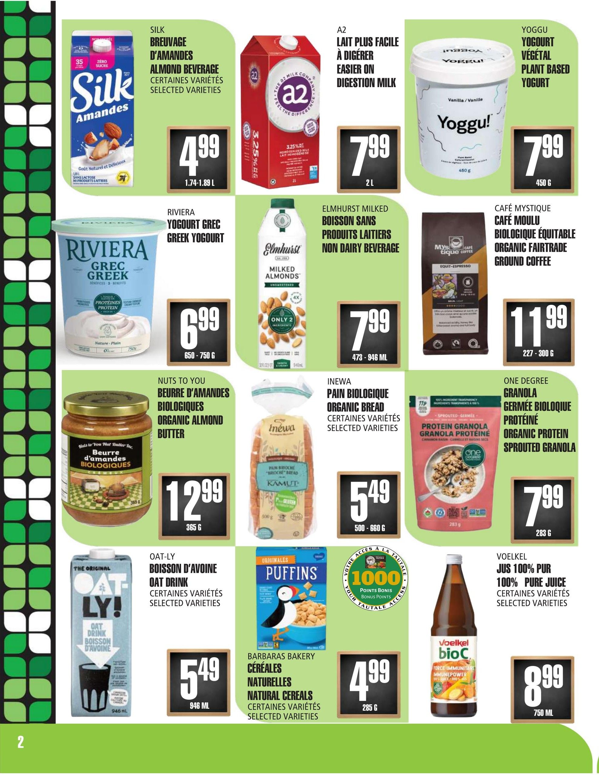 Marches TAU flyer page 2 features a variety of grocery items. Top row includes Silk Almond Beverage for $4.99 (1.74-1.89 L), A2 Easier on Digestion Milk for $7.99 (2 L), and Yoggu Plant Based Yogurt for $7.99 (450 g). Middle row showcases Riviera Greek Yogurt for $6.99 (650-750 g), Elmhurst Milked Almonds Non-Dairy Beverage for $7.99 (473-946 mL), and Café Mystique Organic Fairtrade Ground Coffee for $11.99 (227-300 g). Bottom row features Nuts to You Organic Almond Butter for $12.99 (365 g), Inewa Organic Bread for $5.49 (500-660 g), and One Degree Organic Protein Sprouted Granola for $7.99 (283 g). Additional items include Oat-ly Oat Drink for $5.49 (946 mL), Barbaras Bakery Natural Cereals for $4.99 (285 g), and Voelkel 100% Pure Juice for $8.99 (750 mL). There is also an offer for 1000 bonus points with purchase.