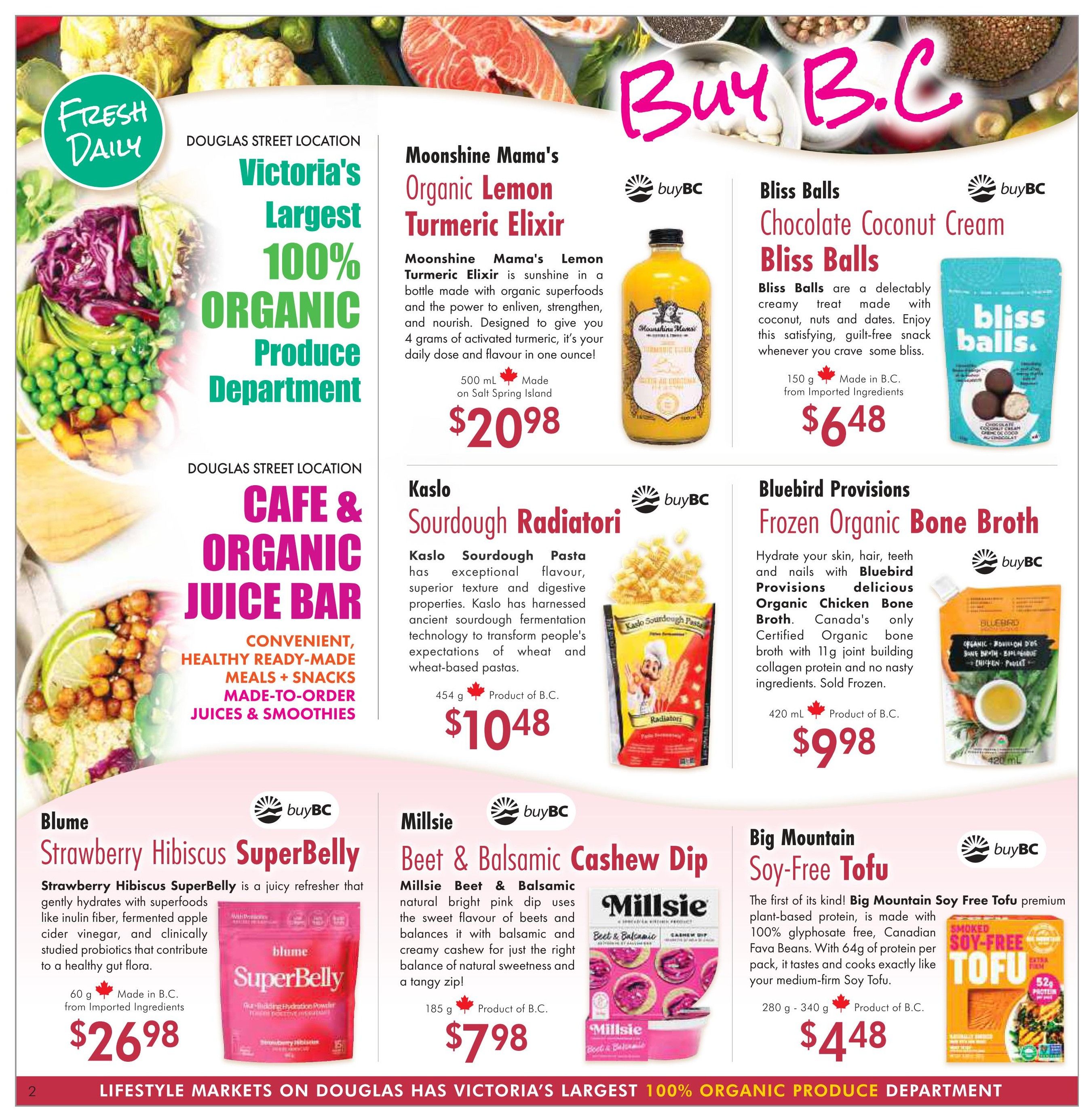 Lifestyle Markets flyer page 2 features 'Buy B.C.' products. Highlights include Moonshine Mama's Organic Lemon Turmeric Elixir for $20.98, Bliss Balls Chocolate Coconut Cream Bliss Balls for $6.48, and Bluebird Provisions Frozen Organic Bone Broth for $9.98. Also featured are Kaslo Sourdough Radiatori pasta for $10.48, Blume Strawberry Hibiscus SuperBelly for $26.98, Millsie Beet & Balsamic Cashew Dip for $7.98, and Big Mountain Soy-Free Tofu for $4.48. The page also promotes the Douglas Street location's 'Fresh Daily' organic produce department and cafe & organic juice bar offering convenient meals, snacks, and made-to-order juices and smoothies.