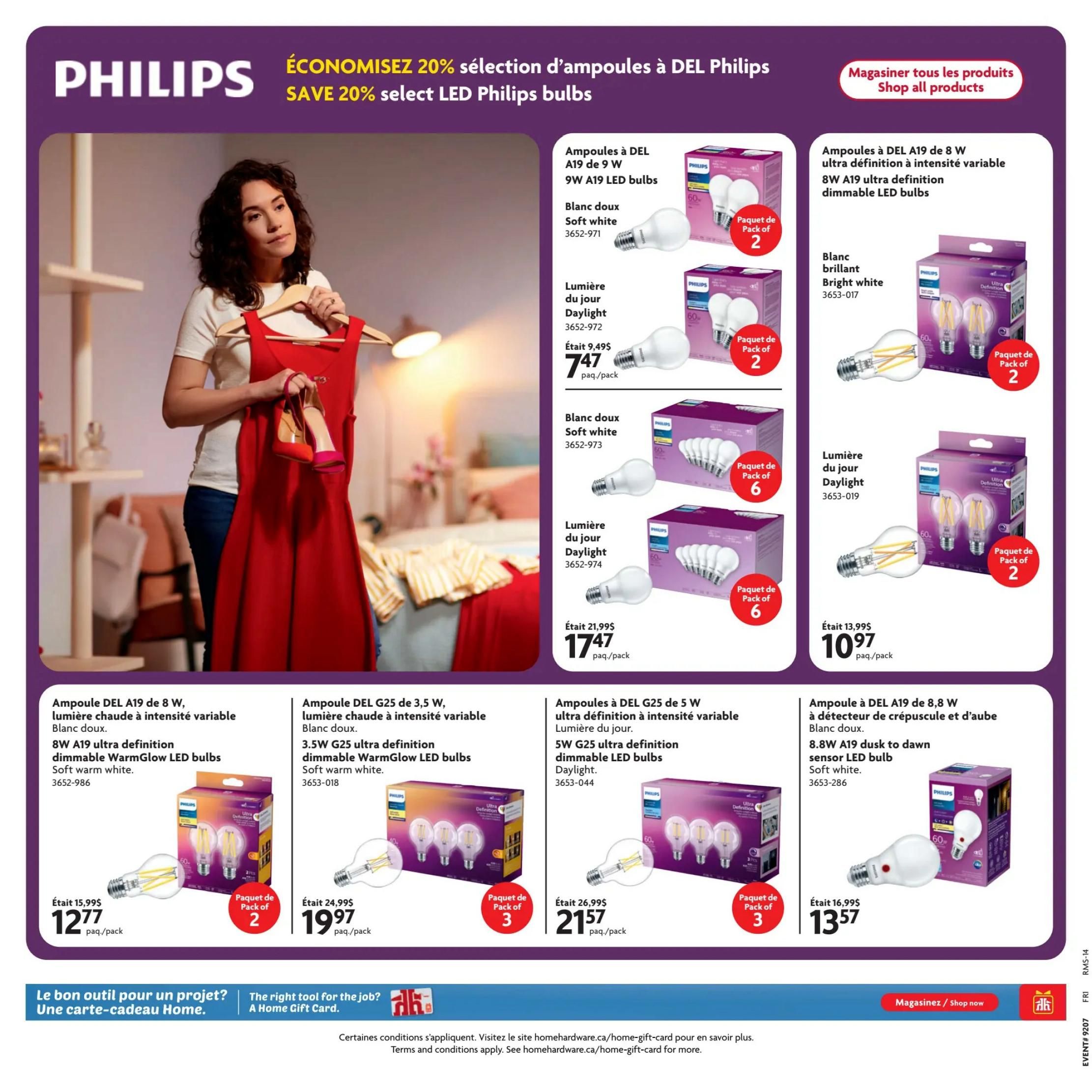 Home Hardware flyer page featuring Philips LED bulbs with a 'Save 20%' promotion. Products include 9W A19 LED bulbs in soft white for $7.47/pack (originally $9.49) and daylight for $7.47/pack (originally $9.49), both in packs of 2. Also available are 8W A19 ultra definition dimmable LED bulbs in bright white for $10.97/pack (originally $13.99) and 8W A19 ultra definition dimmable WarmGlow LED bulbs in soft white for $12.77/pack (originally $15.99), both in packs of 2. Additionally, there are 3.5W G25 ultra definition dimmable LED bulbs in soft warm white for $19.97/pack (originally $24.99) in a pack of 3. Other featured bulbs include 5W G25 ultra definition dimmable LED bulbs in daylight for $21.57/pack (originally $26.99) in a pack of 3, and 8.8W A19 dusk to dawn sensor LED bulbs in soft white for $13.57/pack (originally $16.99) in a pack of 2. The page also highlights a Home Gift Card offer.