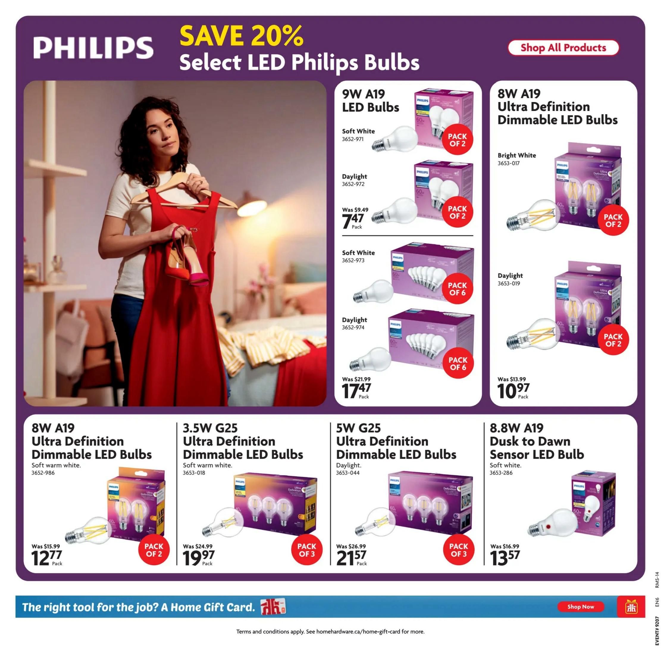 Home Hardware flyer page featuring Philips LED bulbs with a 'Save 20%' promotion. Products include 9W A19 LED Bulbs in Soft White and Daylight, priced at $7.47 per pack of 2. Also available are 8W A19 Ultra Definition Dimmable LED Bulbs in Bright White for $12.77 per pack of 2. The flyer also shows 3.5W G25 Ultra Definition Dimmable LED Bulbs in Soft Warm White for $19.97 per pack of 3, and 5W G25 Ultra Definition Dimmable LED Bulbs in Daylight for $21.57 per pack of 3. Additionally, an 8.8W A19 Dusk to Dawn Sensor LED Bulb in Soft White is offered at $13.57. A button to 'Shop All Products' is visible. The bottom of the page promotes 'The right tool for the job? A Home Gift Card.' and includes a 'Shop Now' button.