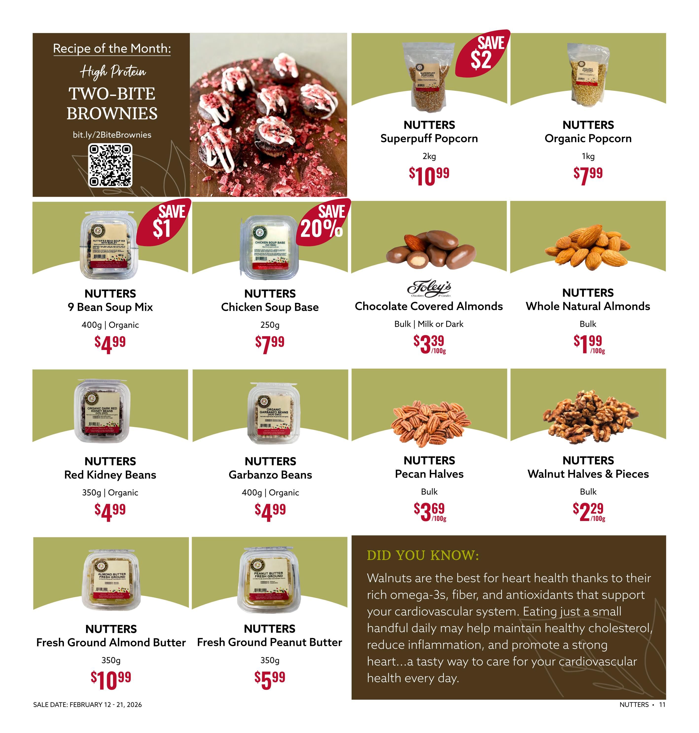 Nutter's Bulk & Natural Foods flyer page 11 features a recipe for High Protein Two-Bite Brownies. On sale are Nutters Superpuff Popcorn 2kg for $10.99, save $2; Nutters Organic Popcorn 1kg for $7.99; Nutters 9 Bean Soup Mix 400g Organic for $4.99, save $1; Nutters Chicken Soup Base 250g for $7.99, save 20%; Foley's Chocolate Covered Almonds Milk or Dark Bulk for $3.39/100g; Nutters Whole Natural Almonds Bulk for $1.99/100g; Nutters Red Kidney Beans 350g Organic for $4.99; Nutters Garbanzo Beans 400g Organic for $4.99; Nutters Pecan Halves Bulk for $3.69/100g; Nutters Walnut Halves & Pieces Bulk for $2.29/100g; Nutters Fresh Ground Almond Butter 350g for $10.99; and Nutters Fresh Ground Peanut Butter 350g for $5.99. The flyer is valid from February 12 - 21, 2026. A 'Did You Know' section highlights the heart health benefits of walnuts.