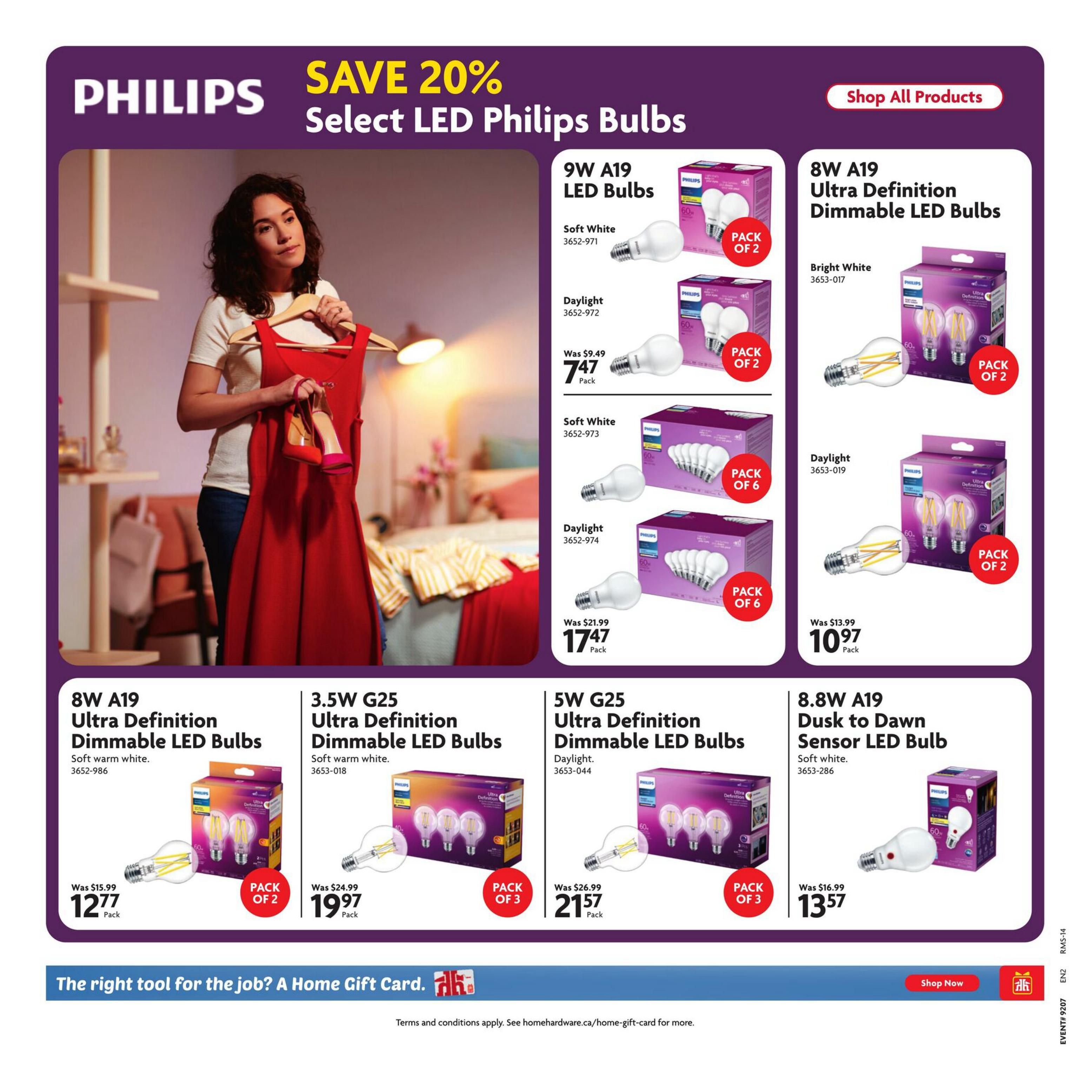 Home Hardware flyer page featuring a selection of Philips LED Bulbs with a 'Save 20%' promotion. Products include 9W A19 LED Bulbs in Soft White and Daylight, priced at $7.47 per pack of 2. Also available are 8W A19 Ultra Definition Dimmable LED Bulbs in Soft warm white, priced at $17.47 per pack of 2. 3.5W G25 Ultra Definition Dimmable LED Bulbs in Soft warm white are $19.97 per pack of 3. 5W G25 Ultra Definition Dimmable LED Bulbs in Daylight are $21.57 per pack of 3. Additionally, 8.8W A19 Dusk to Dawn Sensor LED Bulbs in Soft white are $13.57 per pack. The page also promotes 'Shop All Products' and a Home Gift Card. The bottom banner reads 'The right tool for the job? A Home Gift Card.' with a 'Shop Now' button.