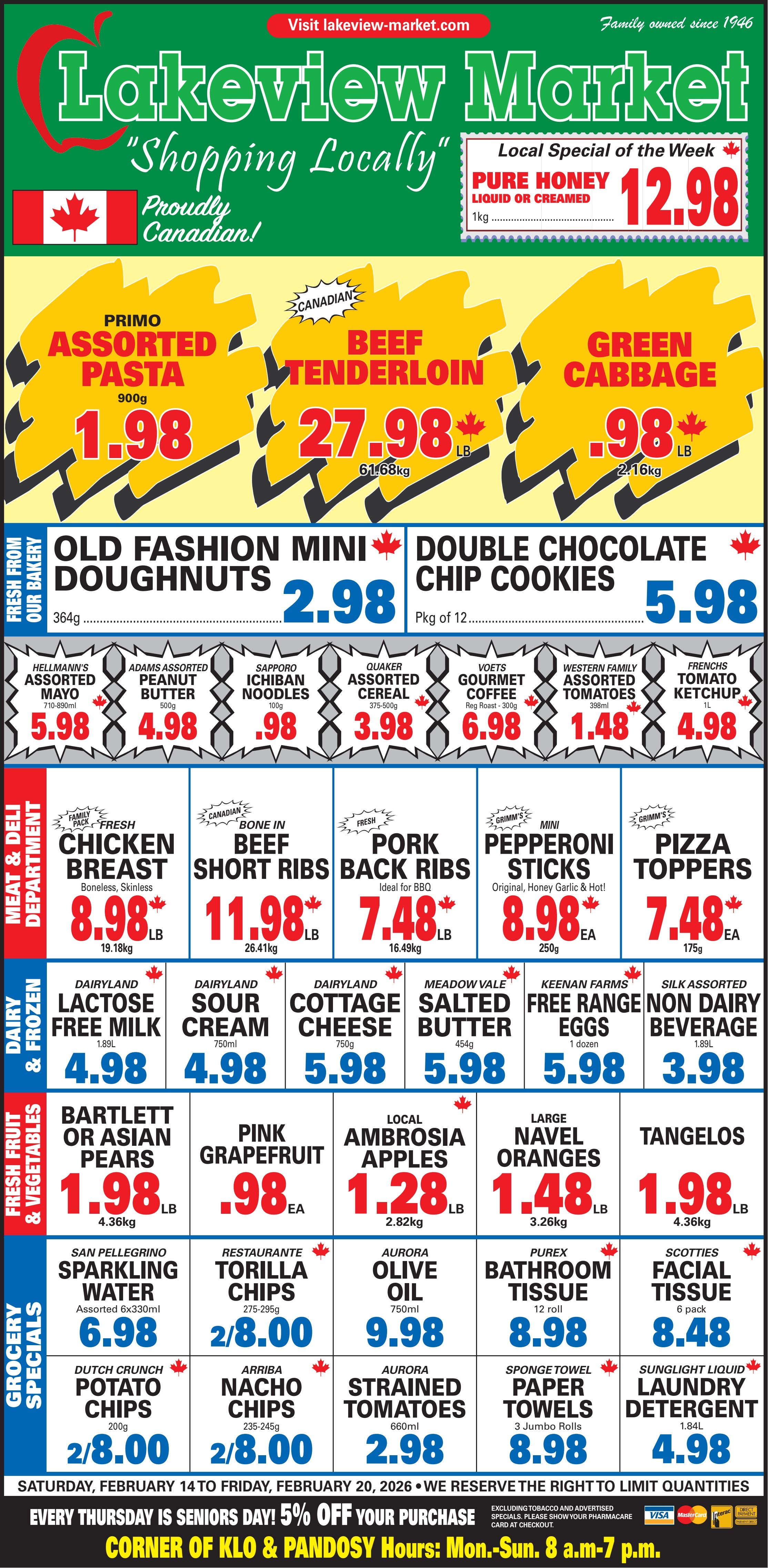 Lakeview Market flyer featuring weekly specials valid February 14 to February 20, 2026. The local special of the week is Pure Honey, liquid or creamed, 1kg for $12.98. Top banner deals include Primo Assorted Pasta 900g for $1.98, Canadian Beef Tenderloin 61.68kg for $27.98 per lb, and Green Cabbage 2.16kg for $0.98 per lb. From the bakery, Old Fashion Mini Doughnuts 364g are $2.98, and Double Chocolate Chip Cookies Pkg of 12 are $5.98. Grocery items feature Hellmann's Assorted Mayo 710-890ml for $5.98, Adams Assorted Peanut Butter 500g for $4.98, Sapporo Ichiban Noodles 100g for $0.98, Quaker Assorted Cereal 375-500g for $3.98, Voets Gourmet Coffee Regular Roast 300g for $6.98, Western Family Assorted Tomatoes 398ml for $1.48, and Frenchs Tomato Ketchup 1L for $4.98. The Meat & Deli department offers Family Pack Fresh Boneless, Skinless Chicken Breast 19.18kg for $8.98 per lb, Canadian Bone In Beef Short Ribs 26.41kg for $11.98 per lb, Fresh Pork Back Ribs 16.49kg for $7.48 per lb, Grimm's Mini Pepperoni Sticks (Original, Honey Garlic & Hot) 250g for $8.98 each, and Grimm's Pizza Toppers 175g for $7.48 each. Dairy & Frozen selections include Dairyland Lactose Free Milk 1.89L for $4.98, Dairyland Sour Cream 750ml for $4.98, Dairyland Cottage Cheese 750g for $5.98, Meadow Vale Salted Butter 454g for $5.98, Keenan Farms Free Range Eggs 1 dozen for $5.98, and Silk Assorted Non Dairy Beverage 1.89L for $3.98. Fresh Fruit & Vegetables include Bartlett or Asian Pears 4.36kg for $1.98 per lb, Pink Grapefruit for $0.98 each, Local Ambrosia Apples 2.82kg for $1.28 per lb, Large Navel Oranges 3.26kg for $1.48 per lb, and Tangelos 4.36kg for $1.98 per lb. Grocery Specials are San Pellegrino Sparkling Water Assorted 6x330ml for $6.98, Restaurante Tortilla Chips 275-295g 2 for $8.00, Aurora Olive Oil 750ml for $9.98, Purex Bathroom Tissue 12 roll for $8.98, Scotties Facial Tissue 6 pack for $8.48, Dutch Crunch Potato Chips 200g 2 for $8.00, Arriba Nacho Chips 235-245g 2 for $8.00, Aurora Strained Tomatoes 660ml for $2.98, Sponge Towel Paper Towels 3 Jumbo Rolls for $8.98, and Sunlight Liquid Laundry Detergent 1.84L for $4.98. The flyer notes that Lakeview Market reserves the right to limit quantities. Every Thursday is Seniors Day, offering 5% off your purchase (excluding tobacco and advertised specials; show your Pharmasave card at checkout). Store hours are Monday to Sunday, 8 a.m. to 7 p.m., located at the corner of Klo & Pandosy.