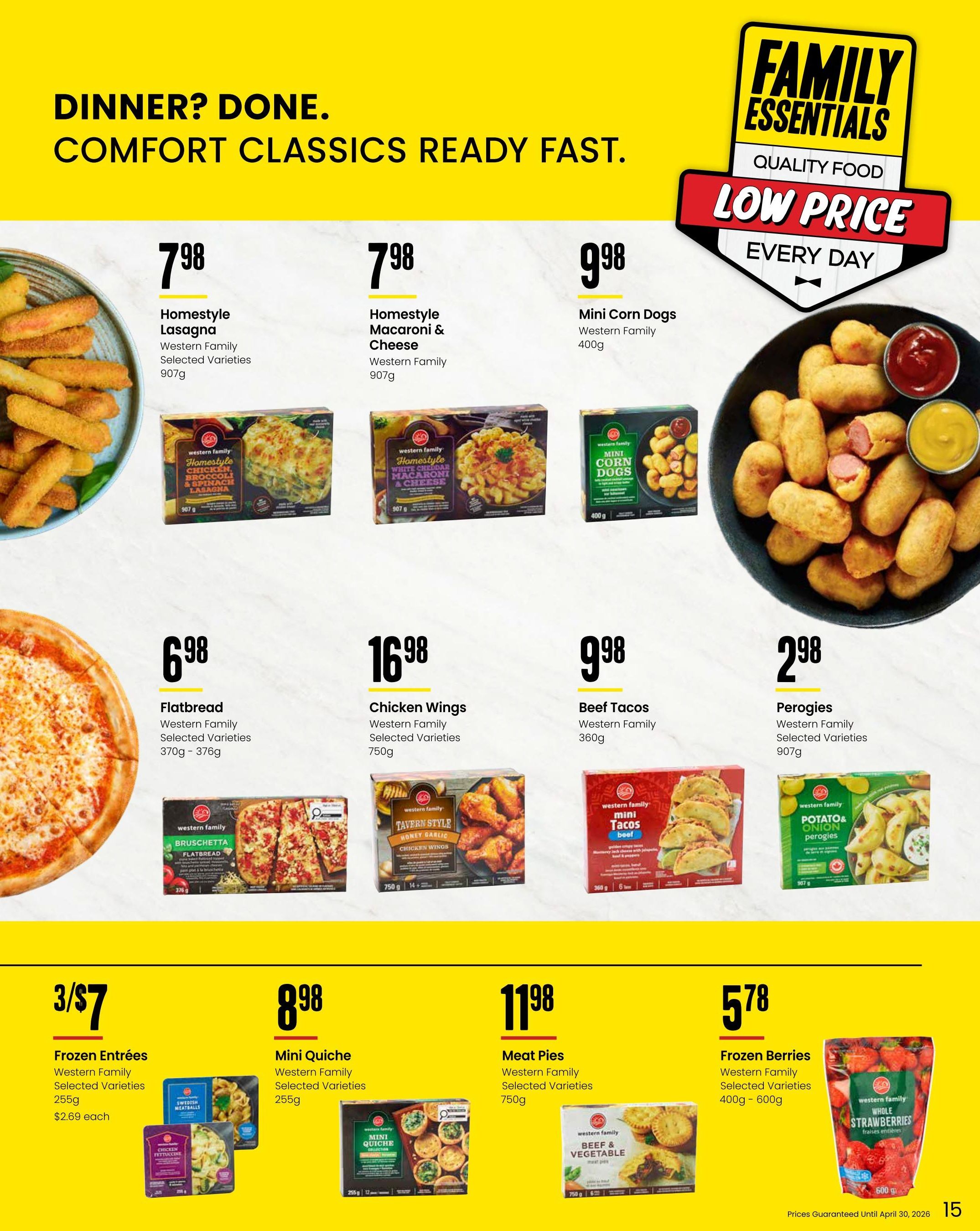 Freson Bros flyer page 15 features 'Dinner? Done. Comfort Classics Ready Fast.' with Family Essentials quality food at low prices. Featured items include Western Family Homestyle Lasagna for $7.98 (907g), Homestyle Macaroni & Cheese for $7.98 (907g), Mini Corn Dogs for $9.98 (400g), Flatbread for $6.98 (370g - 376g), Chicken Wings for $16.98 (750g), Beef Tacos for $9.98 (360g), and Perogies for $2.98 (907g). Also on sale are Western Family Frozen Entrees (Selected Varieties, 255g) for 3 for $7 or $2.69 each, Mini Quiche (Selected Varieties, 255g) for $8.98, Meat Pies (Selected Varieties, 750g) for $11.98, and Frozen Berries (Selected Varieties, 400g - 600g) for $5.78. Prices guaranteed until April 30, 2026.