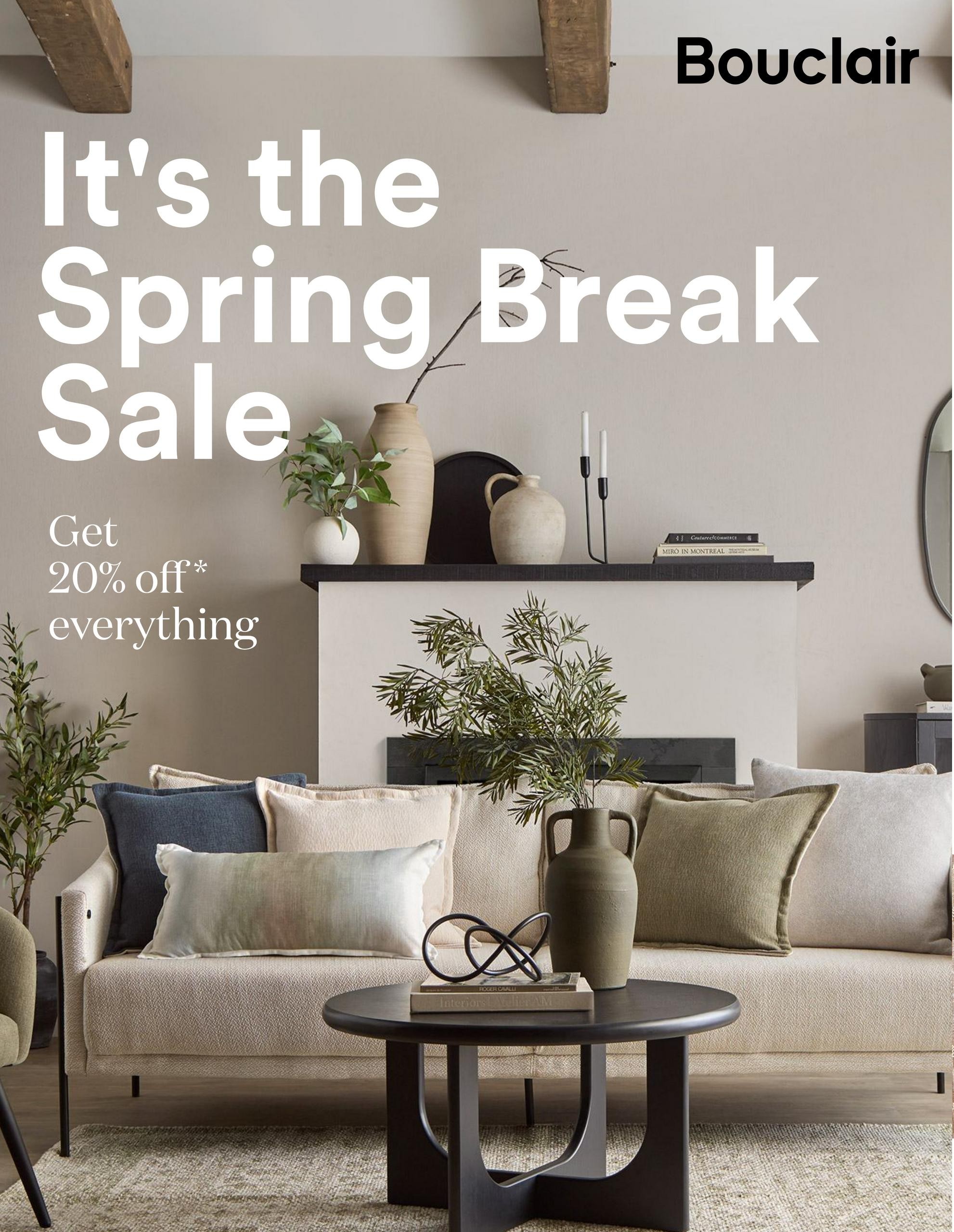Bouclair's Spring Break Sale is on now! Get 20% off everything. The page features a living room scene with a sofa adorned with various decorative pillows, a coffee table with a vase and sculptural accent, and a mantelpiece with decorative vases and candles. This is the first page of the flyer.