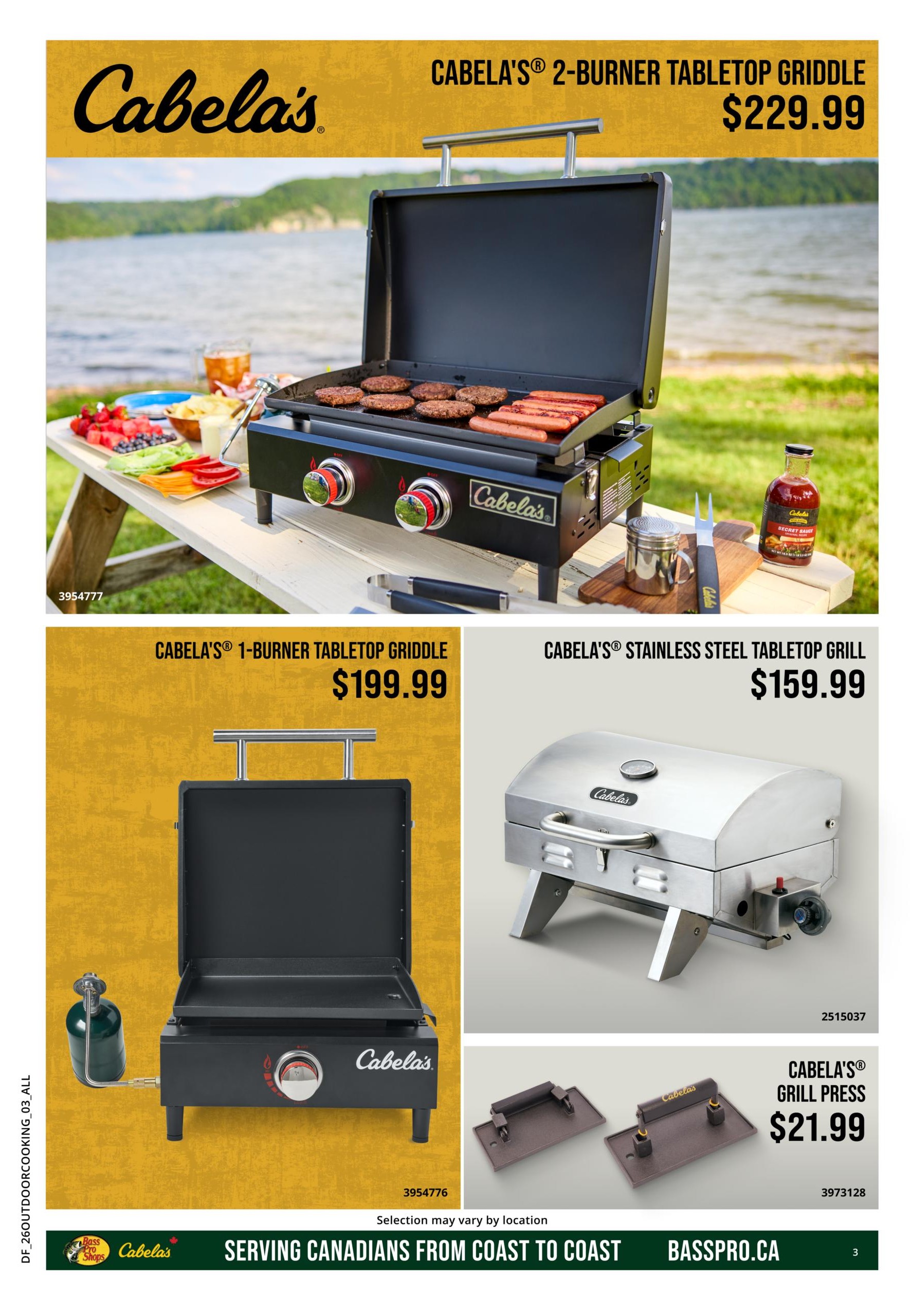 Cabela's flyer page 3 features cooking and grilling equipment. The main item is the Cabela's 2-burner tabletop griddle priced at $229.99. Also featured is the Cabela's 1-burner tabletop griddle for $199.99 and the Cabela's stainless steel tabletop grill for $159.99. Additionally, the Cabela's grill press is available for $21.99. The page includes images of the products in use and on display, with a background of a lakeside picnic setting for the larger griddle.