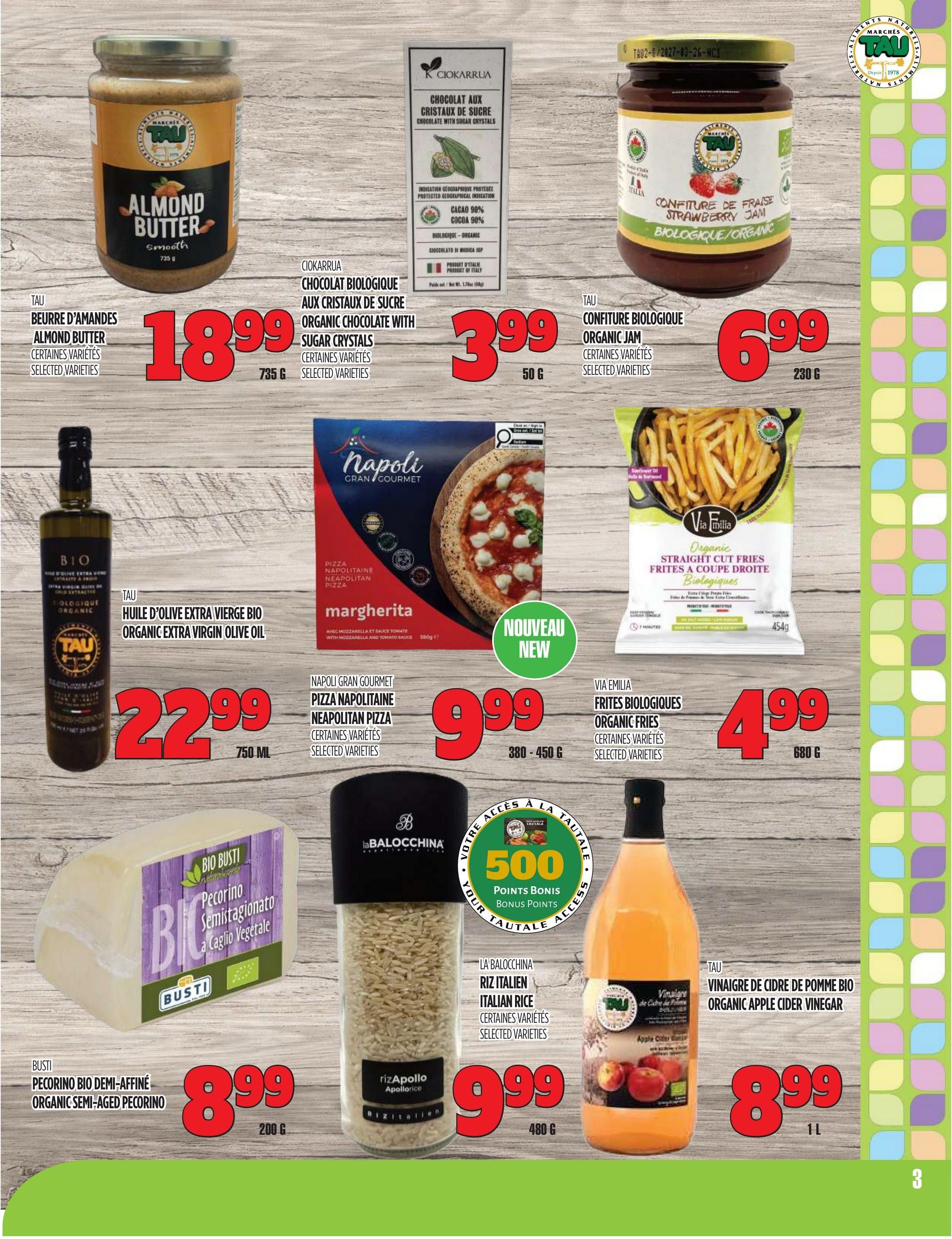 Marches TAU flyer page 3 features a selection of grocery items. Top row includes TAU Almond Butter Smooth for $18.99 (735g), Ciokarrua Organic Chocolate with Sugar Crystals for $3.99 (50g), and TAU Organic Jam (selected varieties) for $6.99 (230g). Middle row showcases TAU Organic Extra Virgin Olive Oil for $22.99 (750ml), Napoli Gran Gourmet Neapolitan Pizza Margherita for $9.99 (380-450g), and Via Emilia Organic Straight Cut Fries for $4.99 (680g). Bottom row features Busti Organic Semi-Aged Pecorino cheese for $8.99 (200g), La Balocchina Italian Rice for $9.99 (480g), and TAU Organic Apple Cider Vinegar for $8.99 (1L). A 'Nouveau New' sticker is on the pizza. visible on the pizza. Bonus points offer for 500 points is also displayed.