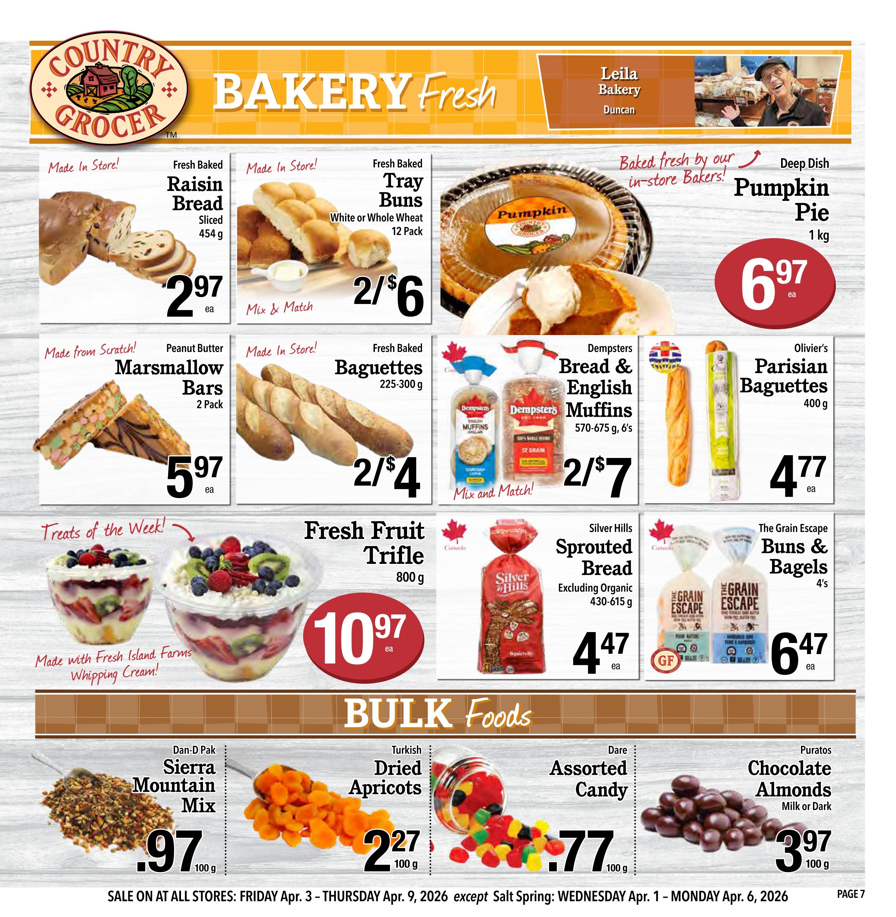 Country Grocer Weekly Flyer Specials Page 7 features bakery fresh items. Highlights include Fresh Baked Raisin Bread sliced, 454g for $2.97 each. Fresh Baked Tray Buns, White or Whole Wheat, 12 Pack, are 2 for $6. Deep Dish Pumpkin Pie, 1kg, is $6.97 each. Made from scratch Peanut Butter Marshmallow Bars, 2 Pack, are $5.97 each. Fresh Baked Baguettes, 225-300g, are 2 for $4. Dempsters Bread & English Muffins, 570-675g, 6's, are 2 for $7. Olivier's Parisian Baguettes, 400g, are $4.77 each. Treats of the Week include Fresh Fruit Trifle, 800g, for $10.97 each, made with Fresh Island Farms Whipping Cream. Also featured is Silver Hills Sprouted Bread, excluding organic, 430-615g, for $4.47 each, and The Grain Escape Buns & Bagels, 4's, for $6.47 each. Bulk Foods include Dan-D Pak Sierra Mountain Mix for $0.97 per 100g, Turkish Dried Apricots for $2.27 per 100g, Dare Assorted Candy for $0.77 per 100g, and Puratos Chocolate Almonds (Milk or Dark) for $3.97 per 100g. Sale is on from Friday, April 3 to Thursday, April 9, 2026.