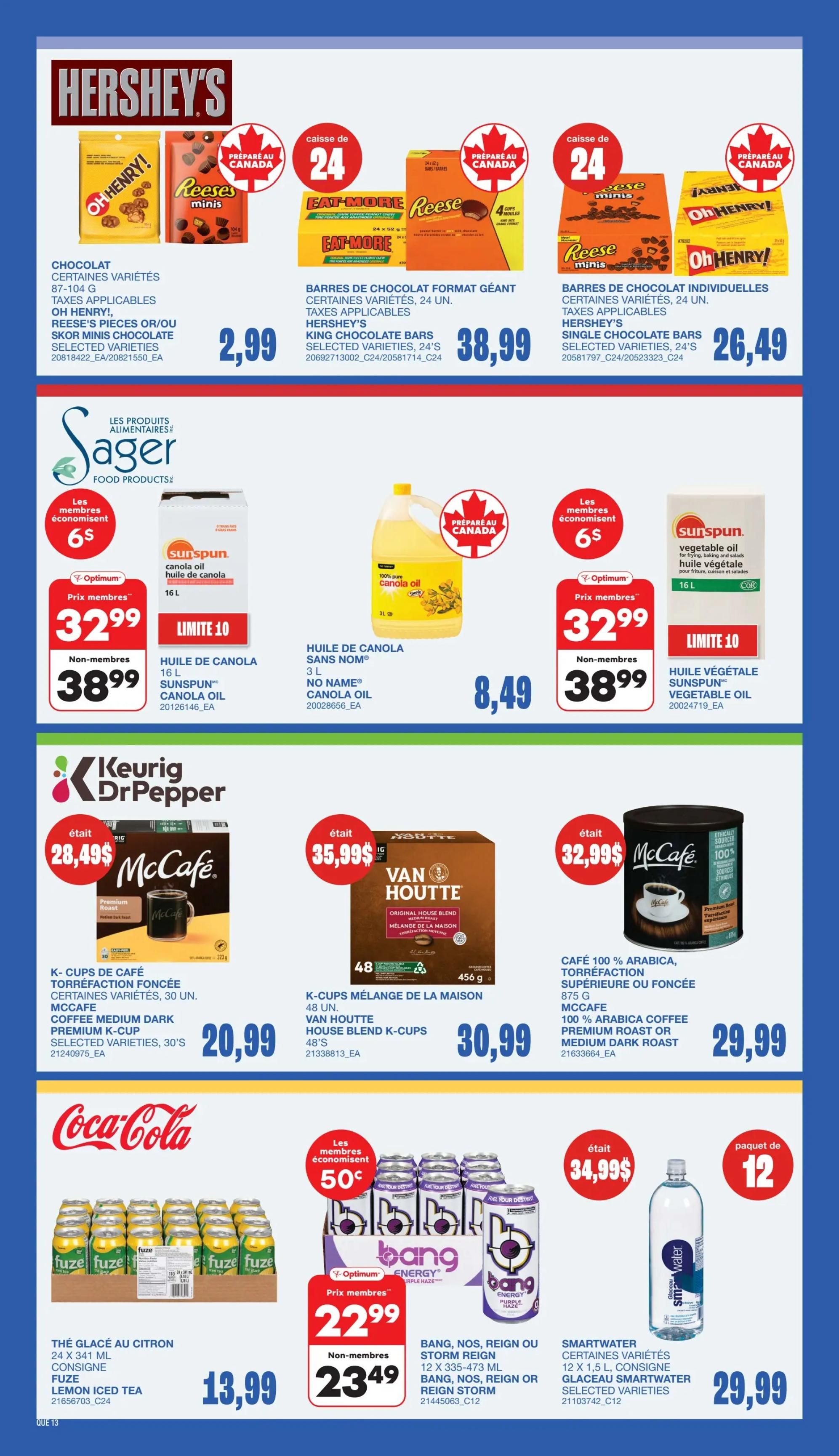 Wholesale Club flyer page 15 featuring Hershey's chocolate bars, Sager Food Products, Keurig Dr Pepper coffee, Coca-Cola beverages, and Bang energy drinks. Offers include Hershey's Oh Henry! and Reese's chocolate bars in various sizes, with a 24-count box of giant format bars for $38.99 and individual bars for $26.49. Sager Food Products include 16L Sunspun canola oil for $32.99 (member price) or $38.99 (non-member), and 3L No Name canola oil for $8.49. Keurig Dr Pepper offers McCafe Premium K-Cups in medium dark roast for $20.99 and Van Houtte Original House Blend K-Cups (48 units) for $30.99. Coca-Cola features Fuze lemon iced tea (24 x 341 ml) for $13.99. Bang energy drinks (NOS, Reign, or Storm Reign) are on special for $22.99 (member price) or $23.49 (non-member). Smartwater 12 x 1.5 L bottles are $29.99.