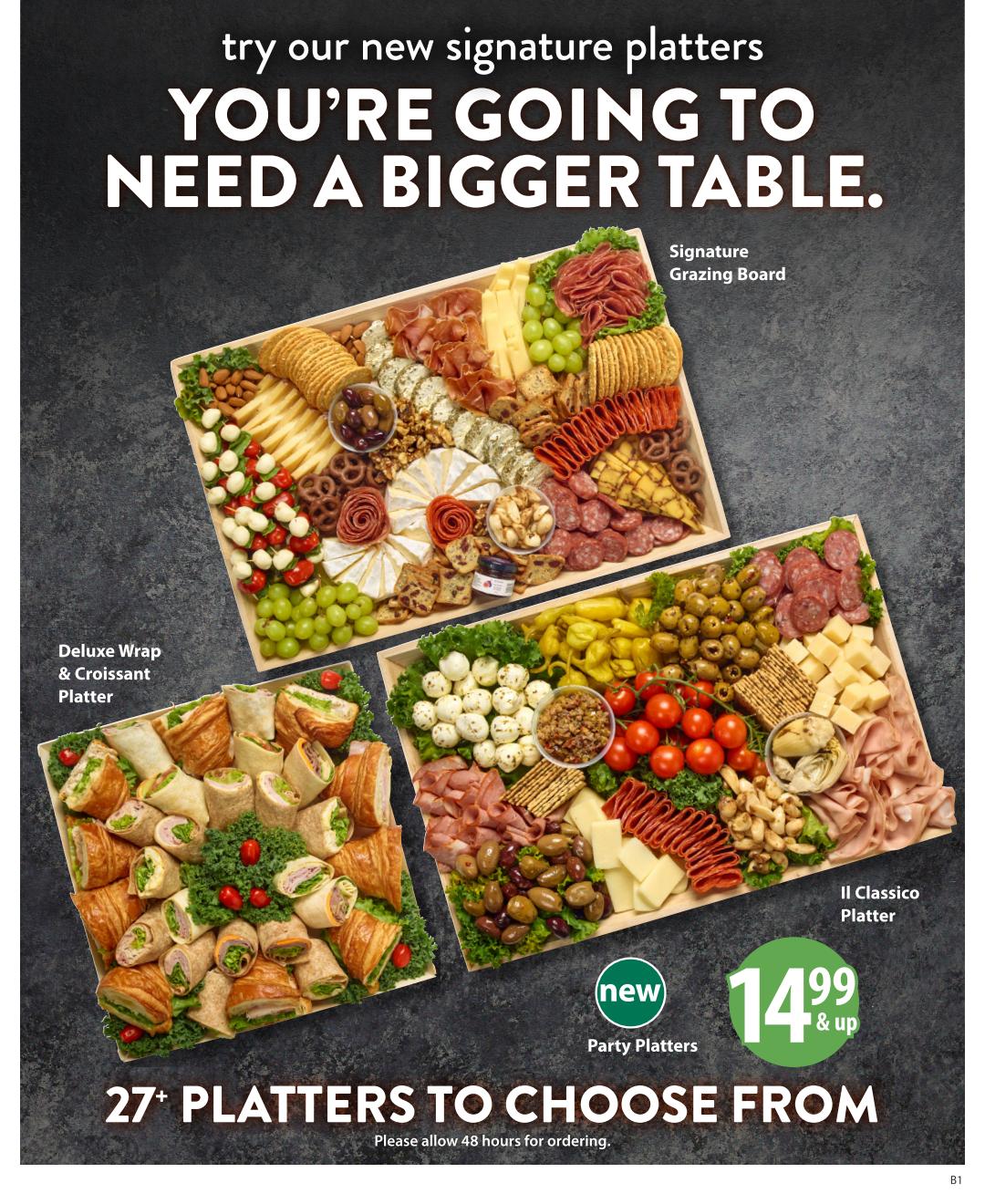 Save-On-Foods flyer page featuring new signature platters with the tagline 'You're Going to Need a Bigger Table.' Showcases three platters: the Deluxe Wrap & Croissant Platter, the Signature Grazing Board with cheeses, meats, fruits, and crackers, and the Il Classico Platter with olives, cheeses, and cured meats. Also highlights new Party Platters starting at $14.99 & up, with over 27 platters to choose from. Orders require 48 hours notice.
