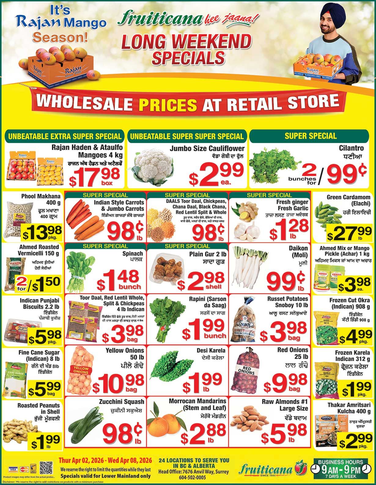 Fruiticana flyer featuring long weekend specials and wholesale prices at retail store. The flyer highlights Rajan Haden & Ataulfo Mangoes, 4 kg box for $17.98. Jumbo Size Cauliflower is available for $2.99 each. Cilantro is on offer at 2 bunches for $0.99. Phool Makhana, 400 g, is priced at $13.98 per package. Indian Style Carrots & Jumbo Carrots are $0.98 per lb. Various DAALS including Toor Daal, Chickpeas, Chana Daal, Black Chana, Red Lentil Split & Whole are $0.98 per lb. Fresh ginger and Fresh Garlic are $1.28 per lb. Green Cardamom (Elachi) is $27.99 per lb. Ahmed Roasted Vermicelli, 150 g, is 2 for $1.50. Spinach is $1.48 per bunch. Plain Gur, 2 lb, is $2.98 per shell. Daikon (Moli) is $0.99 per lb. Ahmed Mix or Mango Pickle (Achar), 1 kg, is $3.98 each. Indican Punjabi Biscuits, 2.2 lb, are $5.98 per package. Toor Daal, Red Lentil Whole, Split & Chickpeas, 4 lb Indican, are $3.98 per bag. Rapini (Sarson da Saag) is $1.99 per bunch. Russet Potatoes Snoboy, 10 lb, are $3.98 per bag. Frozen Cut Okra (Indican), 908 g, is $4.99 per package. Fine Cane Sugar (Indican), 8 lb, is $5.99 per bag. Yellow Onions, 50 lb, are $10.98 per bag. Desi Karela is $1.99 per lb. Red Onions, 25 lb, are $9.98 per bag. Frozen Karela Indican, 312 g, is $1.99 per package. Roasted Peanuts in Shell are $1.99 per lb. Zucchini Squash is $0.98 per lb. Moroccan Mandarins (Stem and Leaf) are $2.88 per lb. Raw Almonds #1 Large Size are $5.98 per lb. Thakar Amritsari Kulcha, 400 g, is $2.99 per package. These specials are valid from Thursday, April 2, 2026, to Wednesday, April 8, 2026, for the Lower Mainland only.
