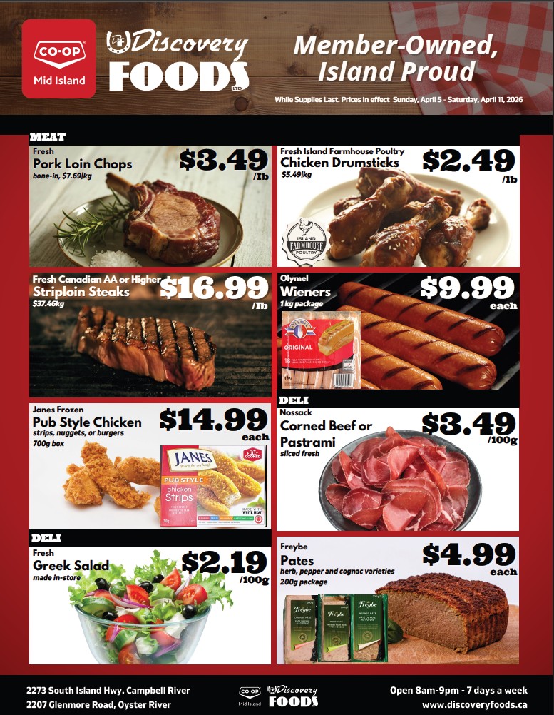 Discovery Foods weekly flyer specials for April 5 to April 11, 2026. Featured meat products include Fresh Pork Loin Chops at $3.49/lb and Fresh Island Farmhouse Poultry Chicken Drumsticks at $2.49/lb. Also available are Fresh Canadian AA or Higher Striploin Steaks for $16.99/lb and Olymel Wieners, 1kg package, for $9.99 each. Deli items include Janes Frozen Pub Style Chicken strips, nuggets, or burgers, 700g box, for $14.99 each, and Nossack Corned Beef or Pastrami, sliced fresh, for $3.49/100g. Fresh Greek Salad made in-store is $2.19/100g. Freybe Pates, in herb, pepper, and cognac varieties, 200g package, are $4.99 each. The flyer also lists the store address and operating hours.