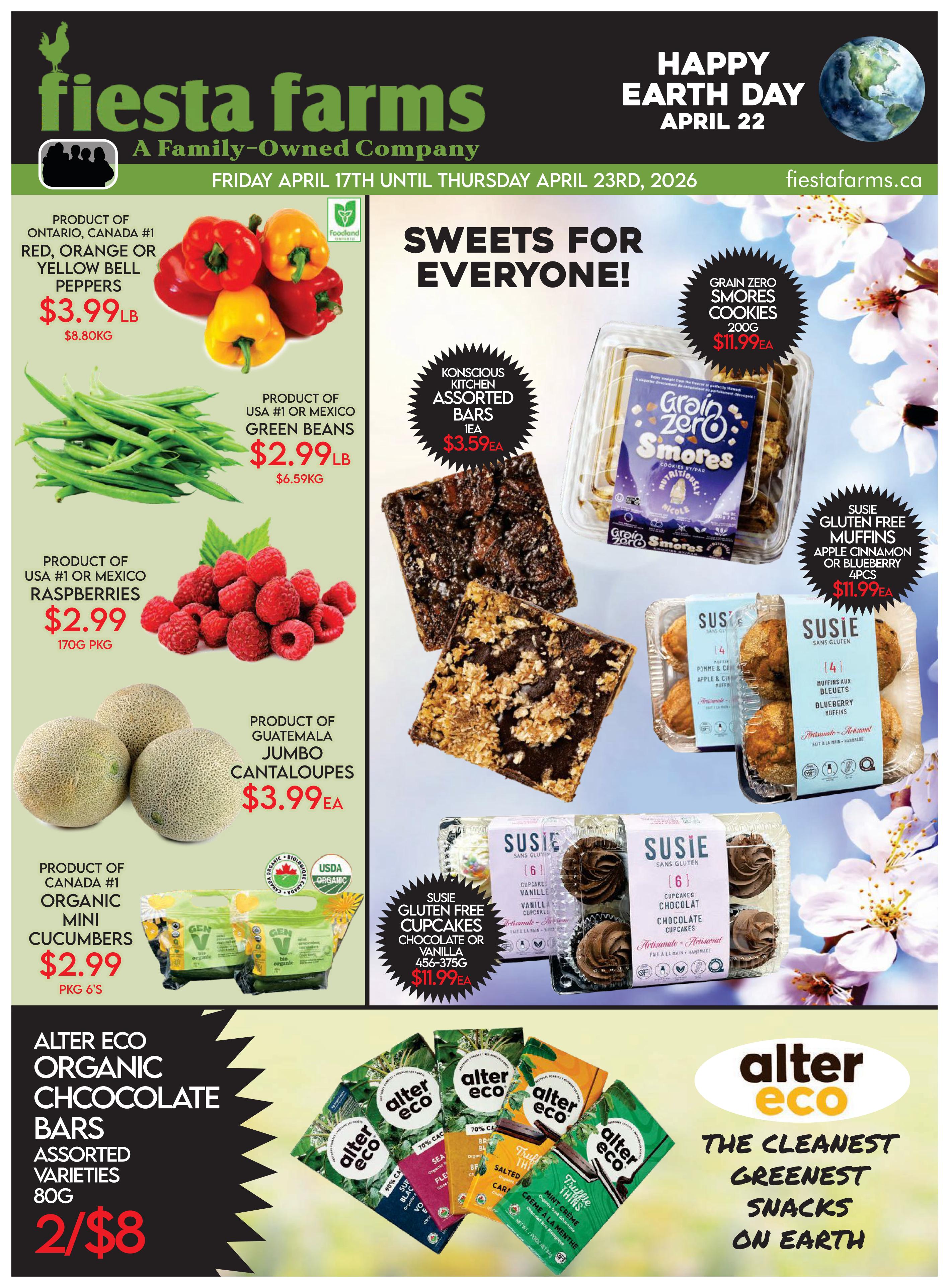 Fiesta Farms weekly flyer specials from Friday, April 17th to Thursday, April 23rd, 2026. Featured produce includes Ontario, Canada #1 Red, Orange or Yellow Bell Peppers for $3.99/lb, USA or Mexico #1 Green Beans for $2.99/lb, USA or Mexico Raspberries for $2.99 per 170g package, Guatemala Jumbo Cantaloupes for $3.99 each, and Canada #1 Organic Mini Cucumbers for $2.99 per package of 6. Sweet treats include Grain Zero Smores Cookies (200g) for $11.99 each, Susie Gluten Free Muffins (Apple Cinnamon or Blueberry, 4pcs) for $11.99 each, and Susie Gluten Free Cupcakes (Chocolate or Vanilla, 456-375g) for $11.99 each. Also featured are Alter Eco Organic Chocolate Bars (Assorted Varieties, 80g) on sale for 2 for $8. The flyer also celebrates Happy Earth Day on April 22nd.