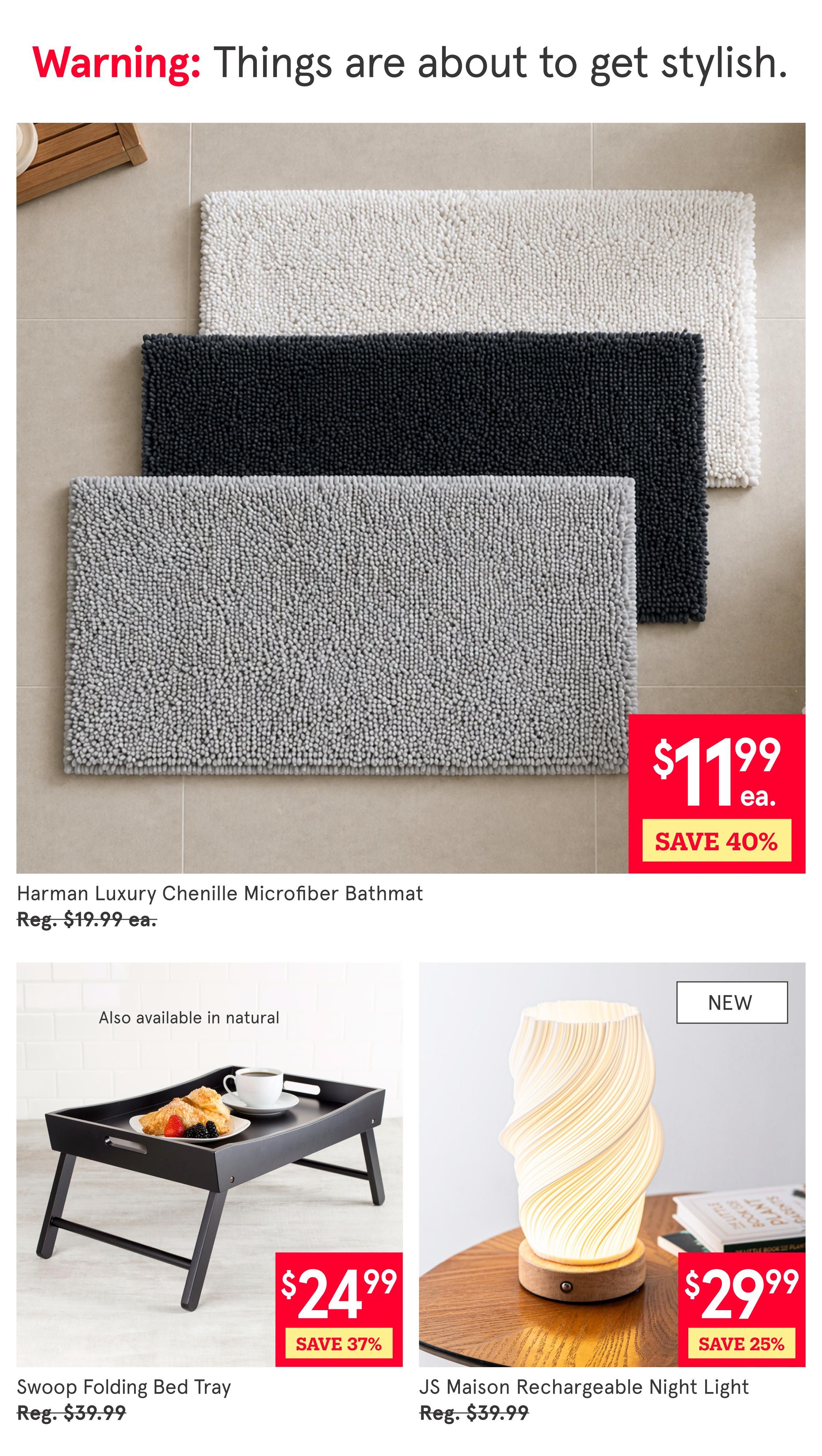 Kitchen Stuff Plus flyer page 8 features home decor items. The Harman Luxury Chenille Microfiber Bathmat is on sale for $11.99 each, saving 40% off the regular price of $19.99. The Swoop Folding Bed Tray is available for $24.99, a 37% saving from its regular price of $39.99. Also shown is the new JS Maison Rechargeable Night Light, priced at $29.99, with a 25% discount from the regular price of $39.99.