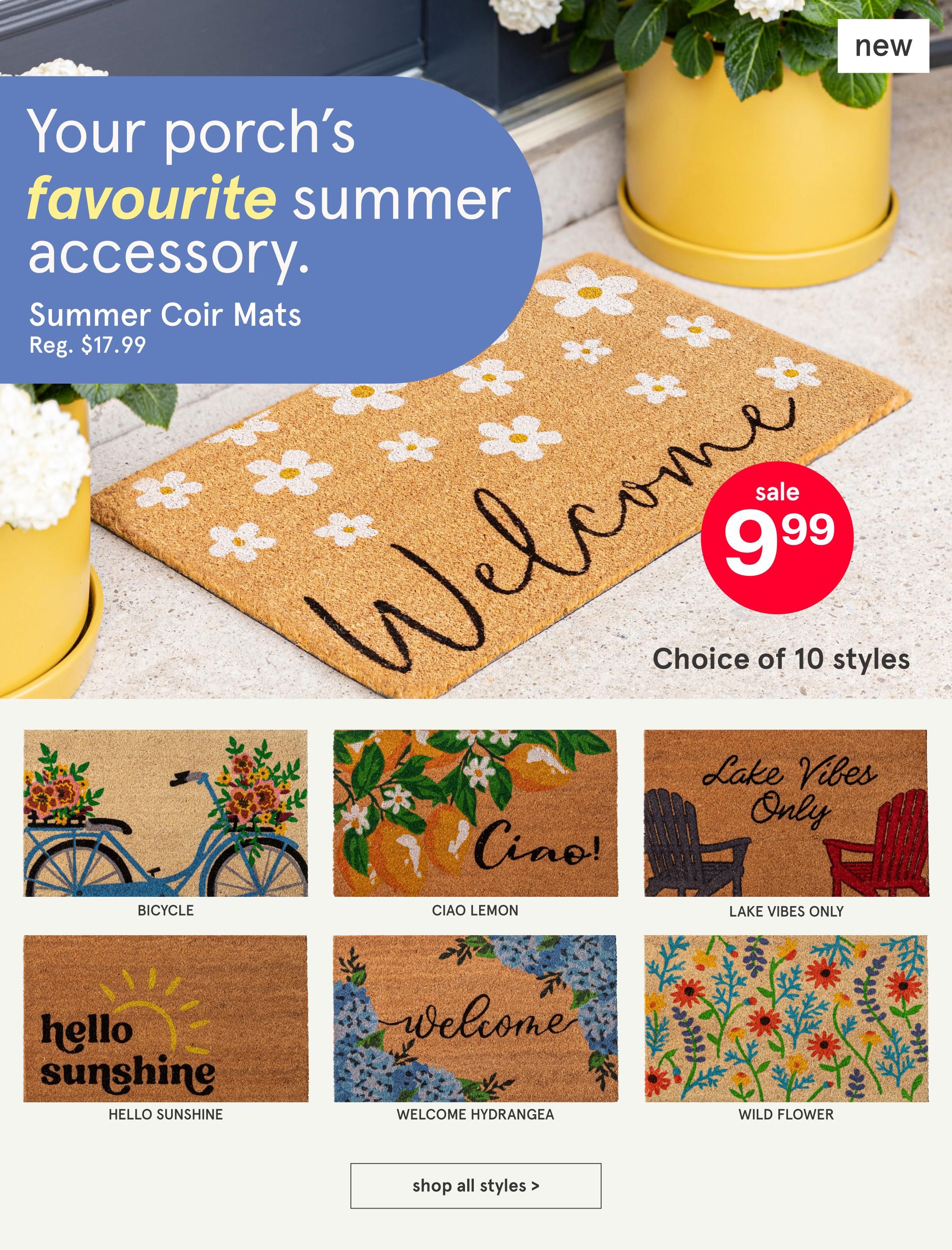 Kitchen Stuff Plus flyer, page 12: Your porch's favourite summer accessory. Summer Coir Mats are on sale for $9.99, regularly $17.99. Choose from 10 styles including a Bicycle design, Ciao Lemon, Lake Vibes Only, Hello Sunshine, Welcome Hydrangea, and Wild Flower. A button to 'shop all styles' is also visible.