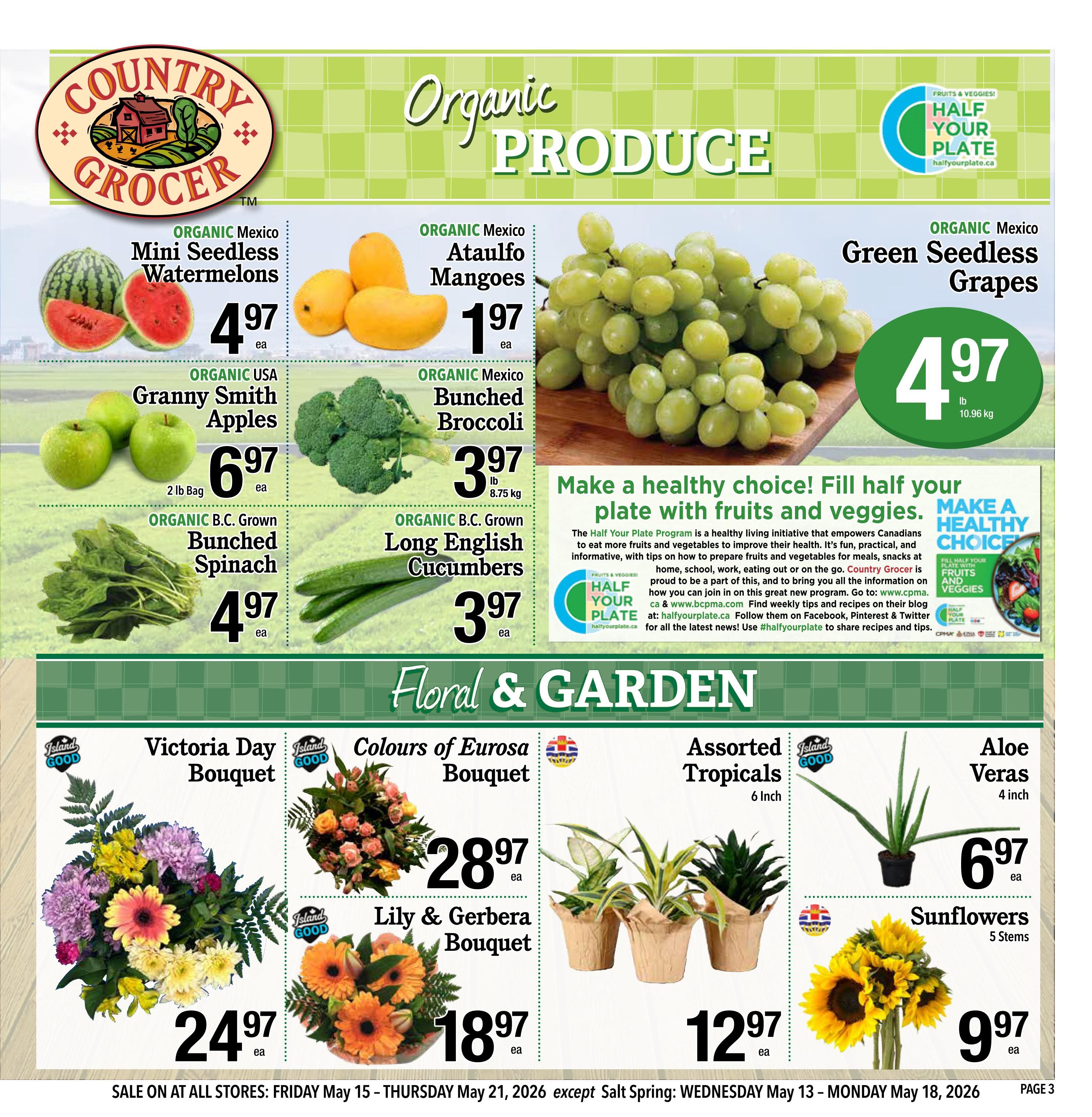 Country Grocer weekly flyer specials page 3 features organic produce including Organic Mexico Mini Seedless Watermelons for $4.97 each, Organic Mexico Ataulfo Mangoes for $1.97 each, and Organic Mexico Green Seedless Grapes for $4.97 per pound (10.96 kg). Also available are Organic USA Granny Smith Apples in a 2 lb bag for $6.97 each, Organic Mexico Bunched Broccoli for $3.97 per lb (8.75 kg), and Organic B.C. Grown Long English Cucumbers for $3.97 each. The page also highlights 'Floral & Garden' items: Victoria Day Bouquet for $24.97 each, Colours of Eurosa Bouquet for $28.97 each, Lily & Gerbera Bouquet for $18.97 each, Assorted Tropicals (6 inch) for $12.97 each, Aloe Veras (4 inch) for $6.97 each, and Sunflowers (5 stems) for $9.97 each. The flyer is valid from Friday, May 15 to Thursday, May 21, 2026, with a note about Salt Spring store hours.