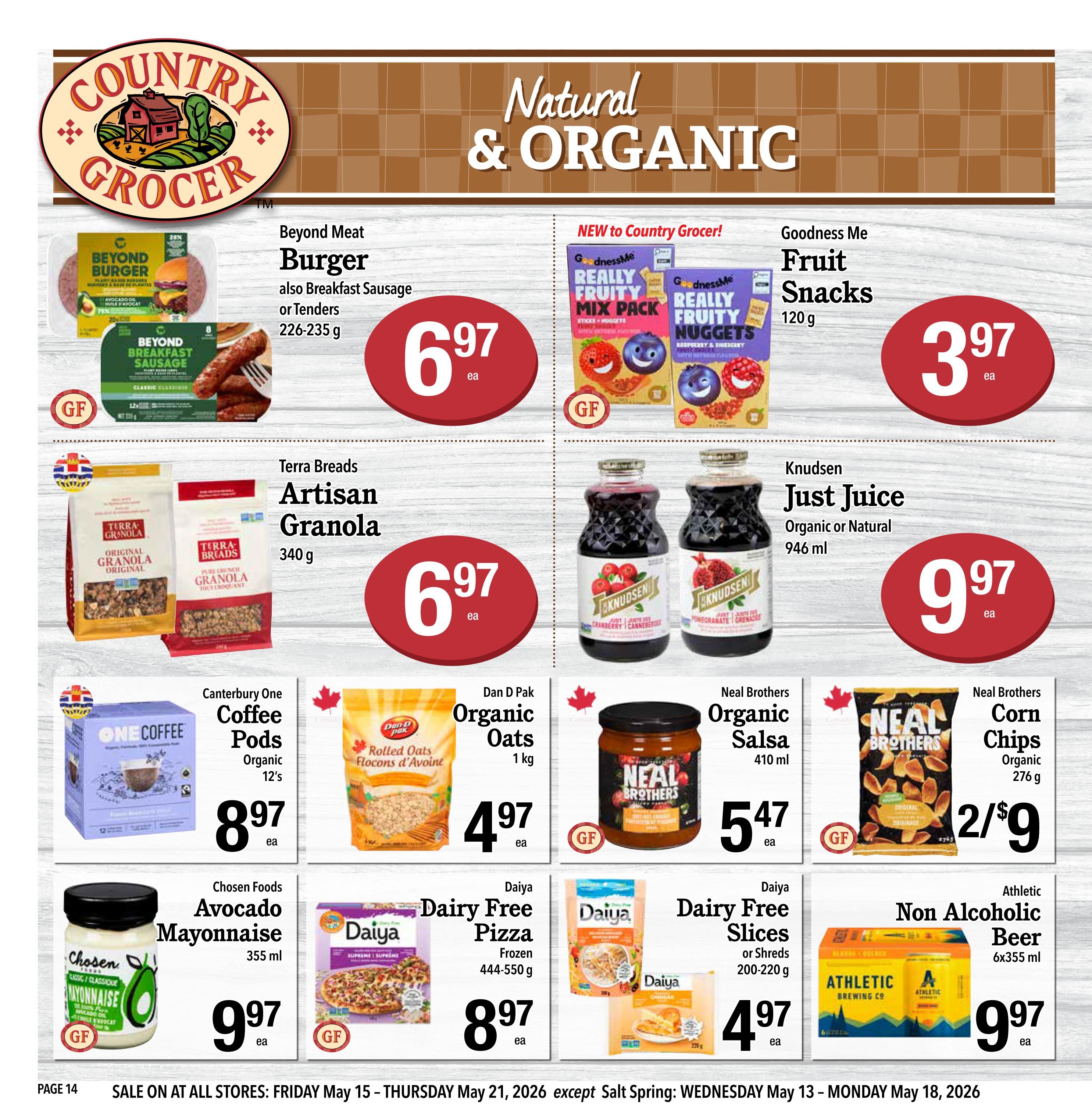 Country Grocer weekly flyer specials page 14 features natural and organic products. Deals include Beyond Meat Burger or Breakfast Sausage or Tenders for $6.97, Goodness Me Really Fruity Mix Pack or Fruity Nuggets for $3.97, Terra Brands Artisan Granola for $6.97, and Knudsen Just Juice Organic or Natural for $9.97. Also available are Canterbury One Coffee Pods for $8.97, Dan D Pak Organic Rolled Oats for $4.97, Neal Brothers Organic Salsa for $5.47, Neal Brothers Organic Corn Chips for 2 for $9, Chosen Foods Avocado Mayonnaise for $9.97, Daiya Dairy Free Pizza for $8.97, Daiya Dairy Free Slices or Shreds for $4.97, and Athletic Non Alcoholic Beer 6x355ml for $9.97. Sale runs Friday May 15 to Thursday May 21, 2026.