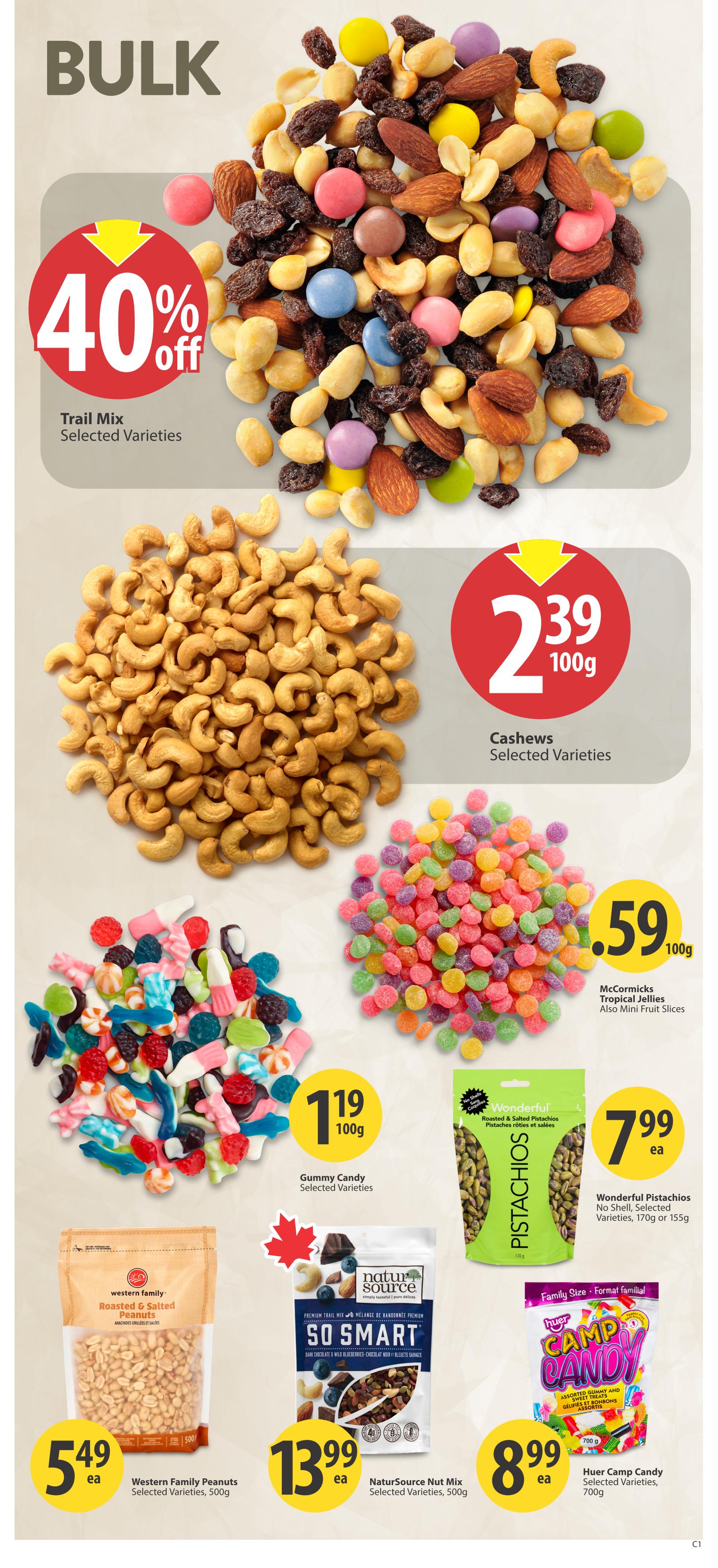 Save-On-Foods weekly flyer specials for Saskatchewan, page 26. Features bulk items including Trail Mix with 40% off, selected varieties. Cashews selected varieties are $2.39 per 100g. Gummy Candy selected varieties are $1.19 per 100g. McCormICKS Tropical Jellies and Mini Fruit Slices are $0.59 per 100g. Wonderful Pistachios, roasted & salted, no shell, selected varieties, 170g or 155g are $7.99 each. Western Family Roasted & Salted Peanuts, 500g, are $5.49 each. NaturSource Nut Mix, So Smart, selected varieties, 500g, is $13.99 each. Huer Camp Candy, assorted gummy and jelly candies, family size 700g, is $8.99 each.