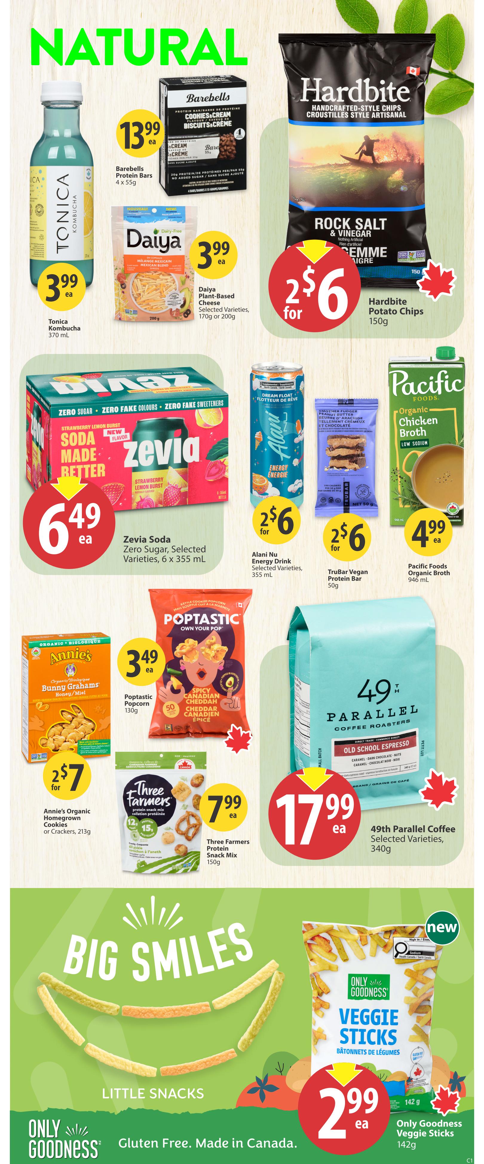 Save-On-Foods weekly flyer specials page 28 featuring natural and organic products. Featured items include Tonica Kombucha for $3.99, Barebells Protein Bars 4 x 55g for $13.99, Daiya Plant-Based Cheese 170g or 200g for $3.99, and Hardbite Potato Chips 150g for 2 for $6. Also on sale is Zevia Soda Zero Sugar, 6 x 355 mL, for $6.49, Alani Nu Energy Drink 355 mL for 2 for $6, and TruBar Vegan Protein Bar 50g for 2 for $6. Pacific Foods Organic Chicken Broth 946 mL is $4.99. Annie's Organic Homegrown Cookies or Crackers 213g are 2 for $7. Three Farmers Protein Snack Mix 150g is $7.99. 49th Parallel Coffee Selected Varieties 340g is $17.99. The 'Big Smiles Little Snacks' section highlights Only Goodness Veggie Sticks 142g for $2.99, which are gluten-free and made in Canada.