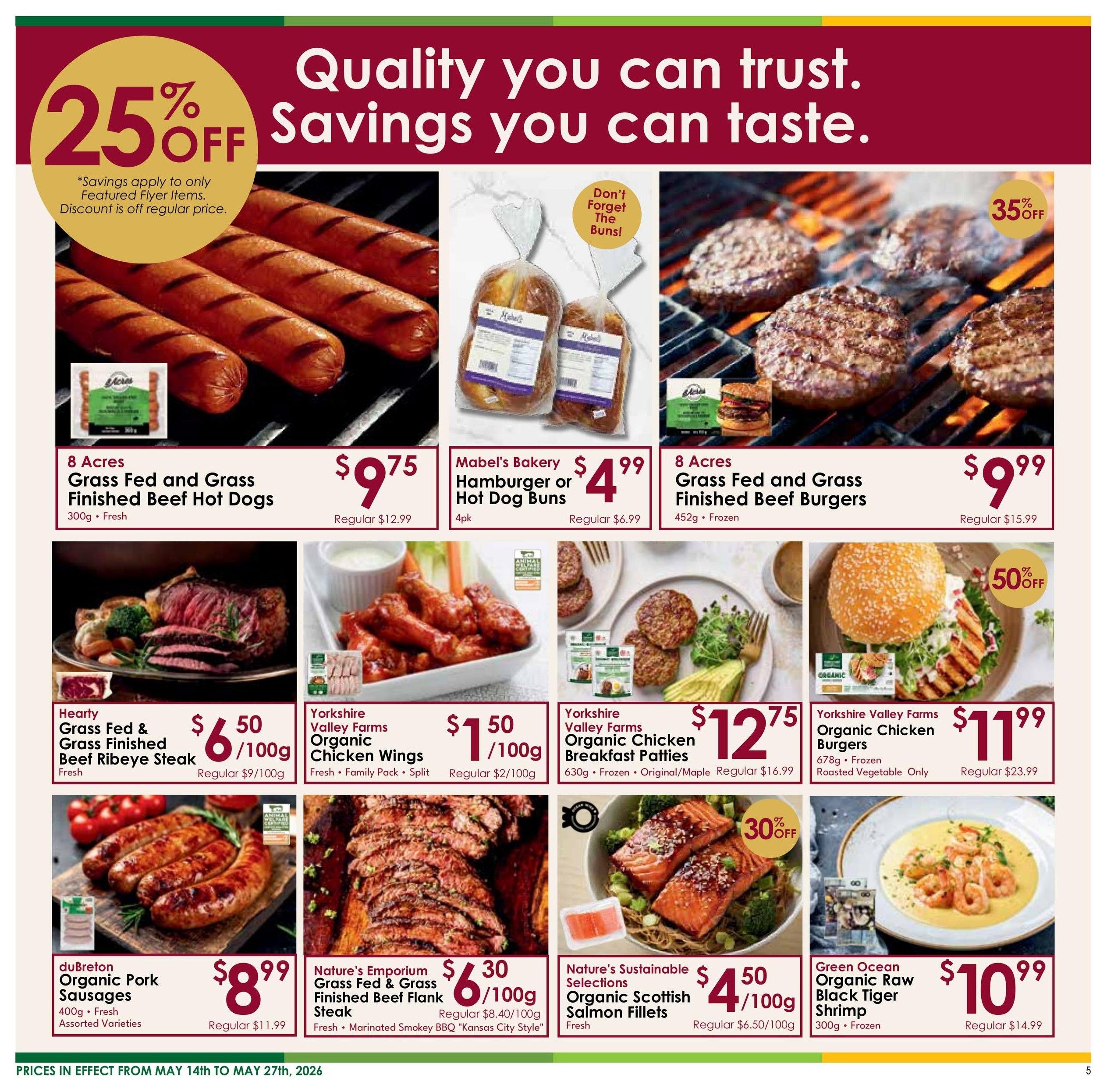 Nature's Emporium flyer page 5 features a 25% off savings on select flyer items. Featured products include 8 Acres Grass Fed and Grass Finished Beef Hot Dogs for $9.75 (regular $12.99), Mabel's Bakery Hamburger or Hot Dog Buns for $4.99 (regular $6.99), and 8 Acres Grass Fed and Grass Finished Beef Burgers for $9.99 (regular $15.99) with a 35% off discount. Also available are Hearty Grass Fed & Grass Finished Beef Ribeye Steak fresh, Yorkshire Valley Farms Organic Chicken Wings fresh family pack split for $1.50/100g (regular $2/100g), Yorkshire Valley Farms Organic Chicken Breakfast Patties frozen original/maple for $12.75 (regular $16.99), Yorkshire Valley Farms Organic Chicken Burgers frozen roasted vegetable for $11.99 (regular $23.99), duBreton Organic Pork Sausages fresh assorted varieties for $8.99 (regular $11.99), Nature's Emporium Grass Fed & Grass Finished Beef Flank Steak marinated smokey BBQ 'Kansas City Style' for $6.30/100g (regular $8.40/100g), Nature's Sustainable Selections Organic Scottish Salmon Fillets fresh for $4.50/100g (regular $6.50/100g) with a 30% off discount, and Green Ocean Organic Raw Black Tiger Shrimp frozen for $10.99 (regular $14.99). Prices are effective May 14th to May 27th, 2026.