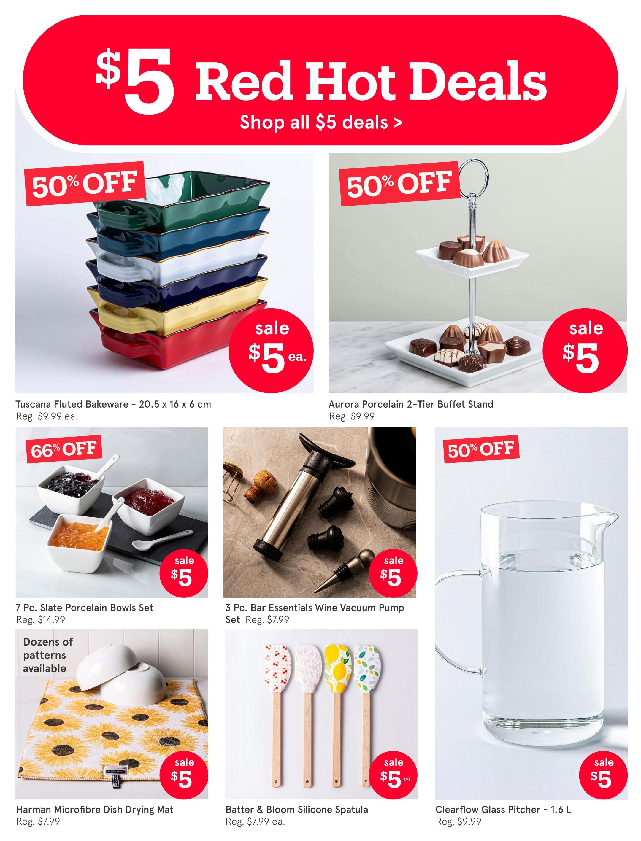 Kitchen Stuff Plus flyer page 13 featuring $5 Red Hot Deals. Items on sale include Tusca Fluted Bakeware (20.5 x 16 x 6 cm) for $5 each, originally $9.99, with 50% off. Aurora Porcelain 2-Tier Buffet Stand is also $5, originally $9.99, with 50% off. A 7 Pc. Slate Porcelain Bowls Set is on sale for $5, originally $14.99, with 66% off. The Bar Essentials Wine Vacuum Pump Set (3 Pc.) is $5, originally $7.99. The Harman Microfibre Dish Drying Mat is $5, originally $7.99, with dozens of patterns available. The Batter & Bloom Silicone Spatula is $5 each, originally $7.99 each. The Clearflow Glass Pitcher (1.6 L) is $5, originally $9.99.