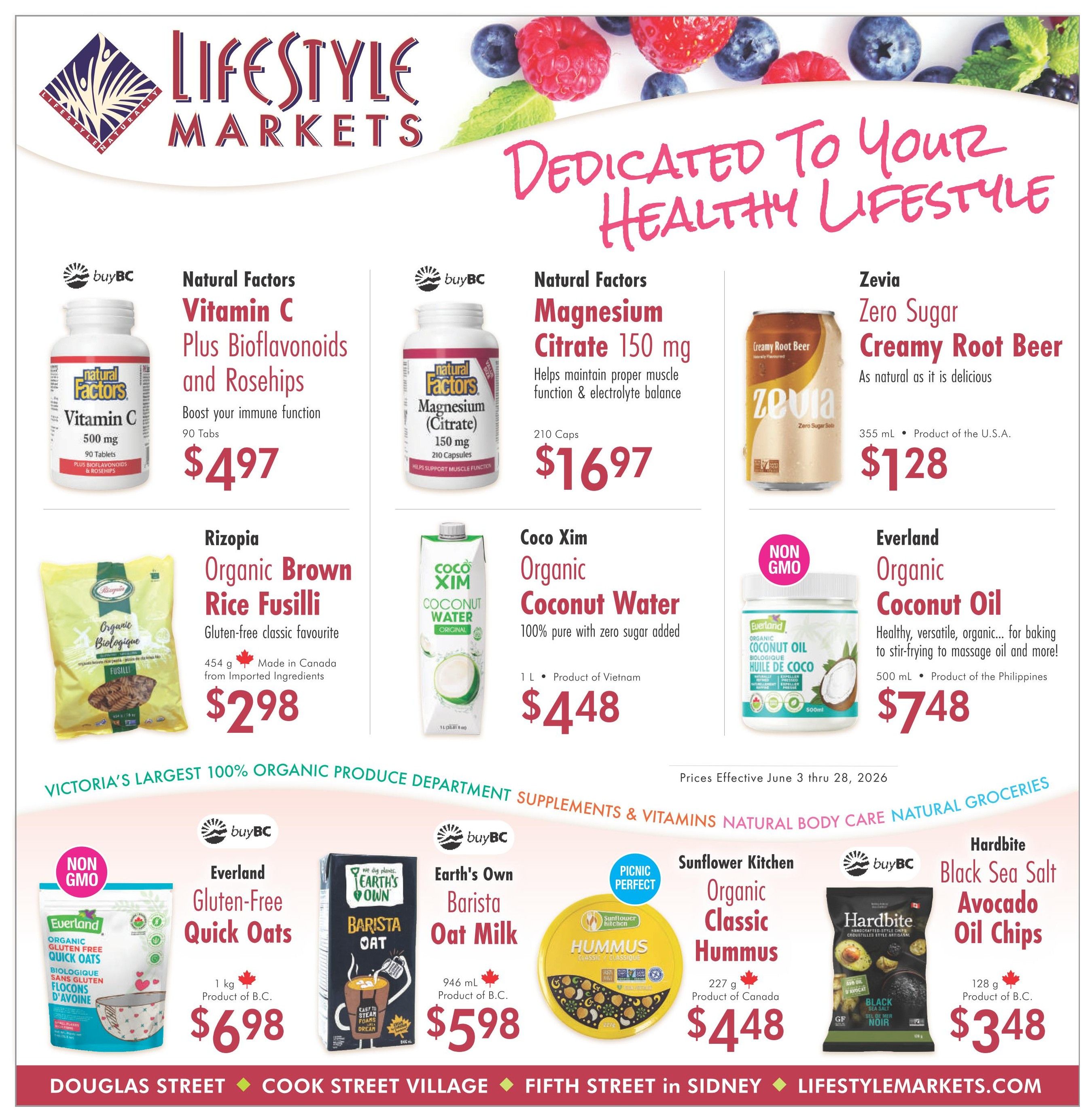 Lifestyle Markets flyer page 1 featuring various health and grocery specials. Top row includes Natural Factors Vitamin C Plus Bioflavonoids and Rosehips for $4.97, Natural Factors Magnesium Citrate 150 mg for $16.97, and Zevia Zero Sugar Creamy Root Beer for $1.28. Middle row showcases Rizopia Organic Brown Rice Fusilli, made in Canada from imported ingredients, for $2.98, Coco Xim Organic Coconut Water (1 L) from Vietnam for $4.48, and Everland Organic Coconut Oil (500 mL) from the Philippines for $7.48. Bottom row highlights Everland Gluten-Free Quick Oats (1 kg) from B.C. for $6.98, Earth's Own Barista Oat Milk (946 mL) from B.C. for $5.98, Sunflower Kitchen Organic Classic Hummus (227 g) from Canada for $4.48, and Hardbite Black Sea Salt Avocado Oil Chips (128 g) from B.C. for $3.48. Prices are effective June 3 to June 28, 2026. The flyer also mentions 'Victoria's Largest 100% Organic Produce Department' and 'Supplements & Vitamins Natural Body Care Natural Groceries'.