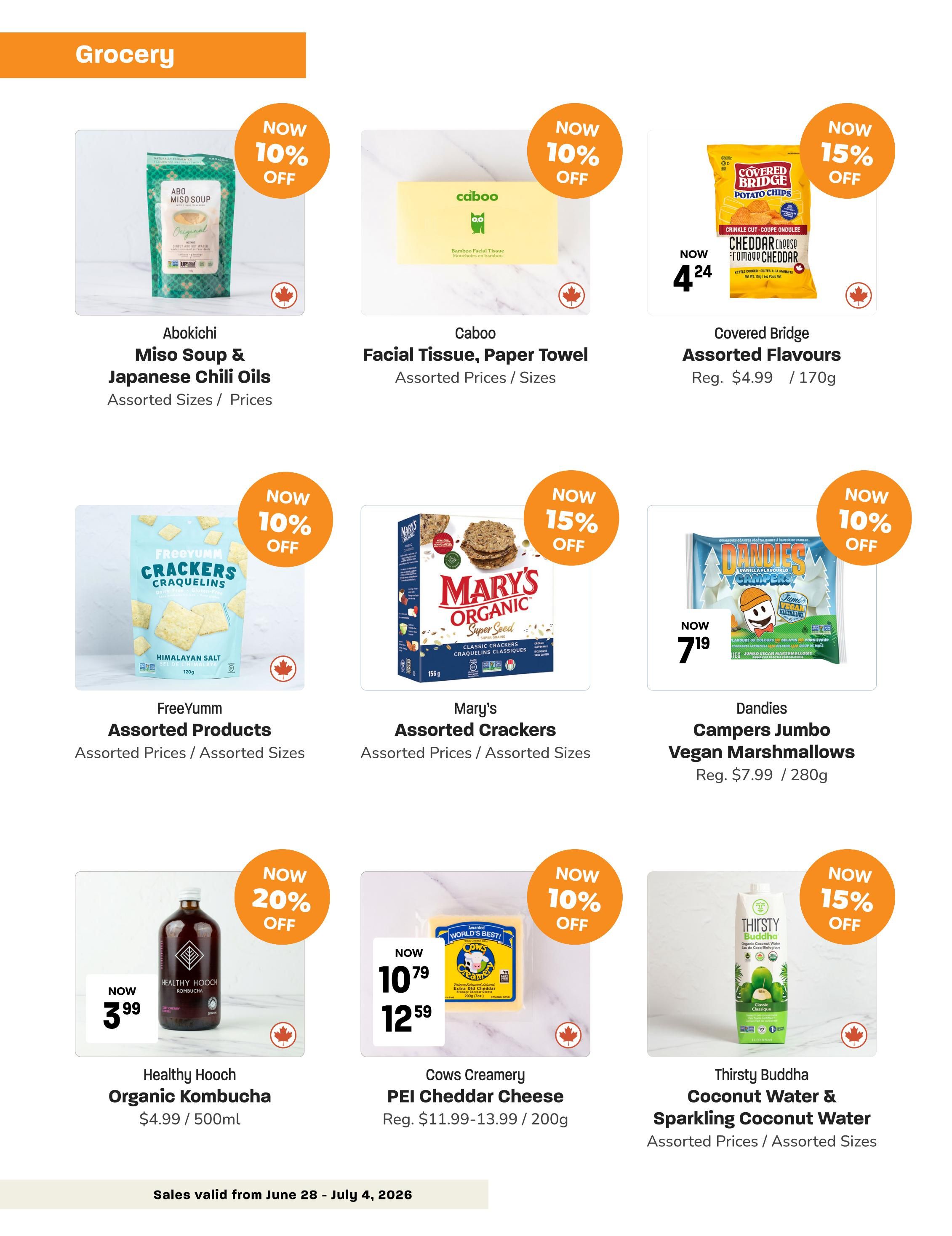 Blush Lane Organic Market weekly flyer specials page 3. Featured grocery items include Abokichi Miso Soup & Japanese Chili Oils, now 10% off. Caboo Facial Tissue, Paper Towel, also 10% off. Covered Bridge Assorted Flavours Potato Chips are 15% off, now $4.24 (regular $4.99 / 170g). FreeYumm Assorted Products Crackers are 10% off. Mary's Assorted Crackers are 15% off. Dandies Campers Jumbo Vegan Marshmallows are 10% off, now $7.19 (regular $7.99 / 280g). Healthy Hooch Organic Kombucha is 20% off, now $3.99 (regular $4.99 / 500ml). Cows Creamery PEI Cheddar Cheese is 10% off, now $10.79 (regular $11.99-13.99 / 200g). Thirsty Buddha Coconut Water & Sparkling Coconut Water is 15% off. Sales valid from June 28 - July 4, 2026.
