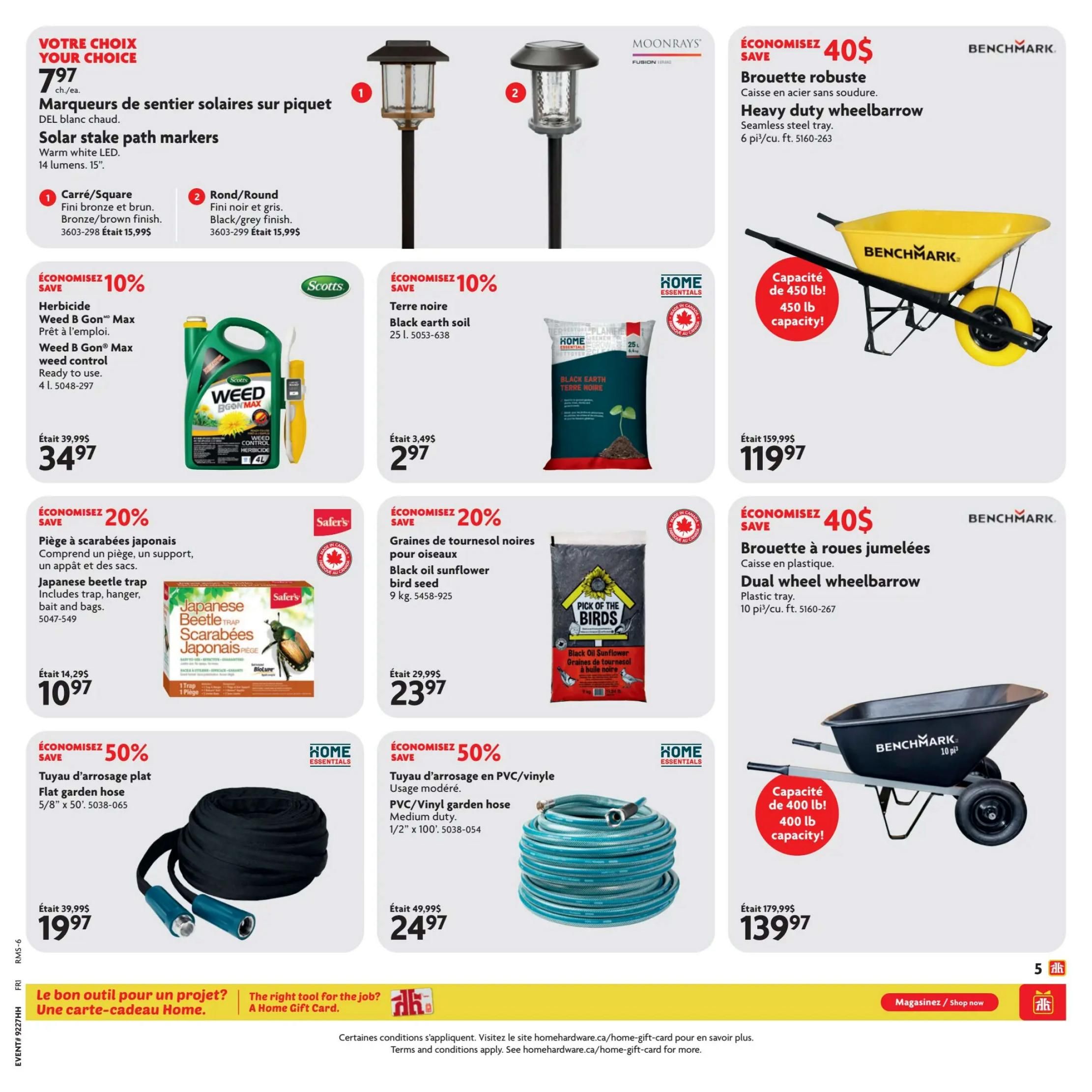 Home Hardware flyer page 6 features a variety of home and garden products. Top left, Solar stake path markers are on sale for $7.97 each, available in warm white LED with 14 lumens and 15' length, in square bronze/brown finish or round black/grey finish. To the right, a Benchmark heavy duty wheelbarrow with a seamless steel tray is on sale for $40 off, priced at $119.97, with a 450 lb capacity. Below the path markers, Scotts Weed B Gon Max weed control, ready to use, 4L, is 10% off, selling for $34.97 (was $39.99). Next to it, Home Essentials black earth soil, 25L, is 10% off, priced at $2.97 (was $3.49). Below the weed control, Safer's Japanese beetle trap, including hanger, bait and bags, is 20% off, selling for $10.97 (was $14.29). Next to it, Pick of the Birds black oil sunflower bird seed, 9kg, is 20% off, priced at $23.97 (was $29.99). On the bottom left, a Home Essentials flat garden hose, 5/8' x 50', is 50% off, selling for $19.97 (was $39.99). To its right, a Home Essentials PVC/vinyl garden hose, medium duty, 1/2' x 100', is 50% off, priced at $24.97 (was $49.99). Finally, a Benchmark dual wheel wheelbarrow with a plastic tray and 400 lb capacity is on sale for $40 off, priced at $139.97 (was $179.99).