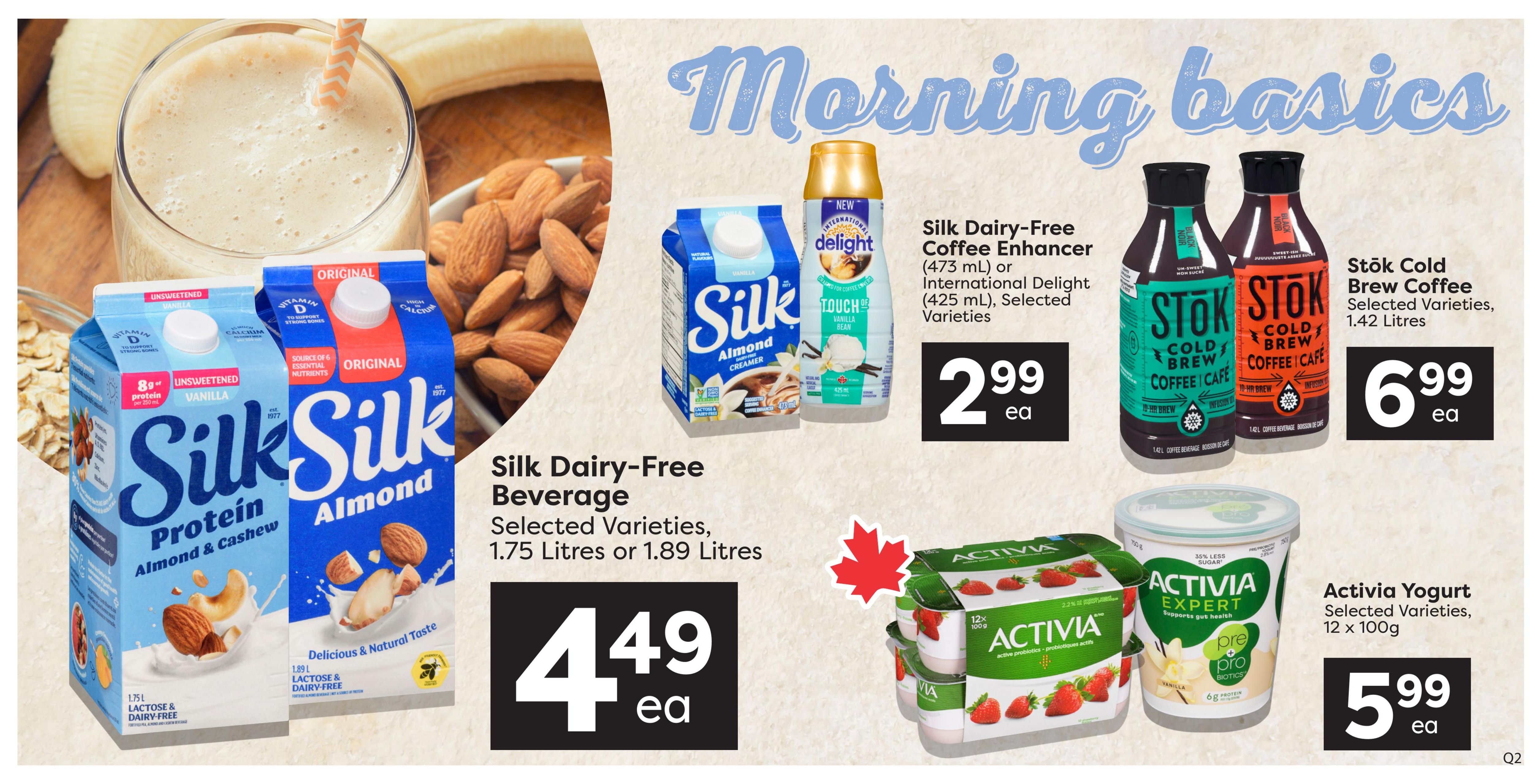 Quality Foods weekly flyer specials page 12 features 'Morning Basics' products. On the left, Silk Dairy-Free Beverage in Protein Almond & Cashew and Almond varieties are available in 1.75 Litres or 1.89 Litres for $4.49 each. Next to it, Silk Dairy-Free Coffee Enhancer in Original Delight and International varieties (473 mL) or International Delight (425 mL) are on sale for $2.99 each. In the centre, Stök Cold Brew Coffee in selected varieties, 1.42 Litres, is priced at $6.99 each. On the right, Activia Yogurt in selected varieties, 12 x 100g, is available for $5.99 each.
