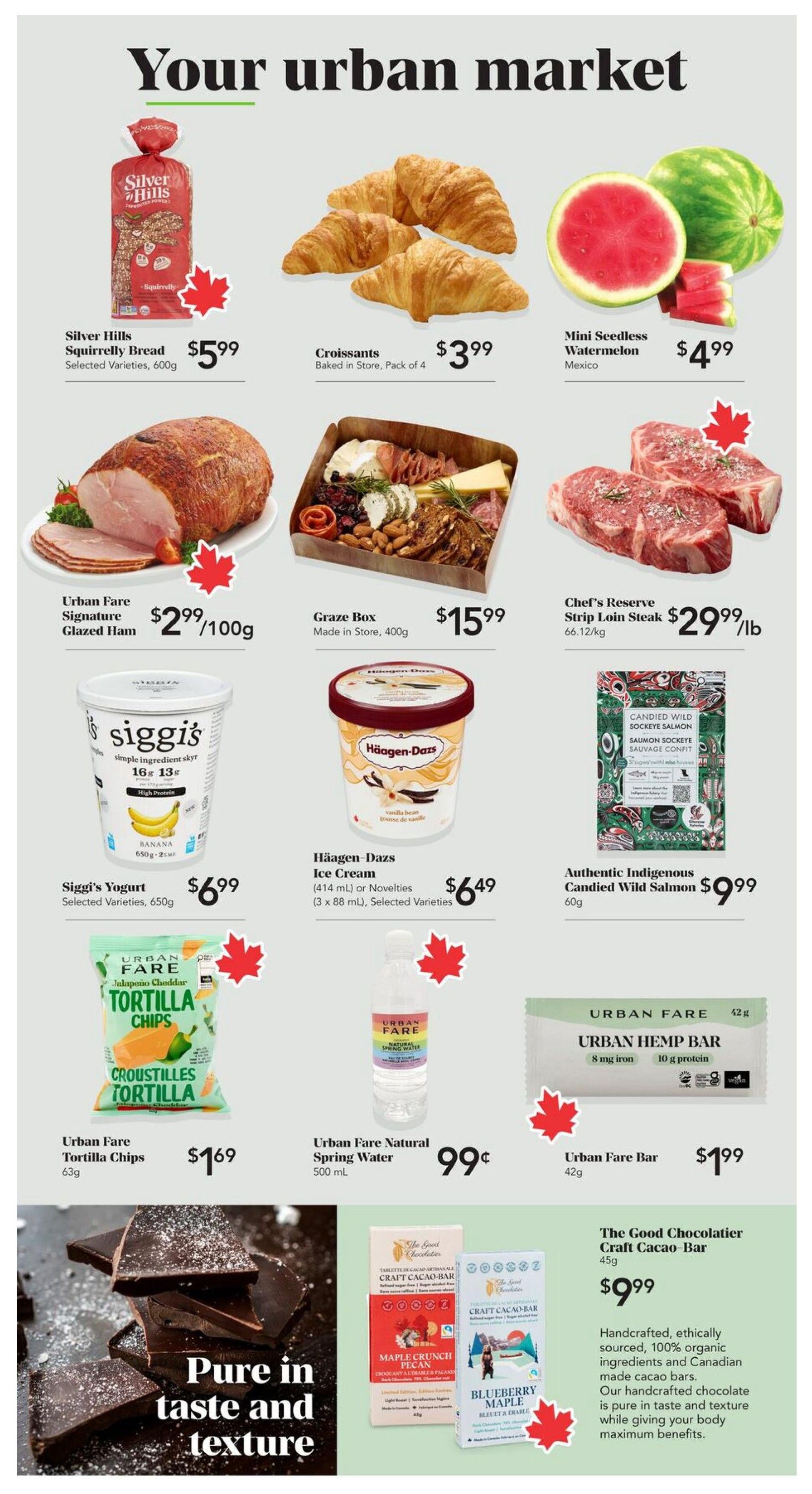 Urban Fare weekly flyer specials page 2. Featuring Silver Hills Squirrely Bread selected varieties 600g for $5.99, Croissants baked in store pack of 4 for $3.99, and Mini Seedless Watermelon from Mexico for $4.99. Also available is Urban Fare Signature Glazed Ham at $2.99 per 100g, a Graze Box made in store 400g for $15.99, and Chef's Reserve Strip Loin Steak at $29.99 per lb. Siggi's Yogurt selected varieties 650g is $6.99, and Häagen-Dazs Ice Cream (414 mL or Novelties 3 x 88 mL) selected varieties are $6.49. Urban Fare Jalapeno Cheddar Tortilla Chips 63g are $1.69, Urban Fare Natural Spring Water 500 mL is 99 cents, and an Urban Fare Bar 42g is $1.99. Authentic Indigenous Candied Wild Salmon 60g is $9.99. The Good Chocolatier Craft Cacao-Bar 45g is $9.99, described as handcrafted, ethically sourced, 100% organic ingredients and Canadian made cacao bars, pure in taste and texture while giving your body maximum benefits. Large image of dark chocolate pieces with text 'Pure in taste and texture'.