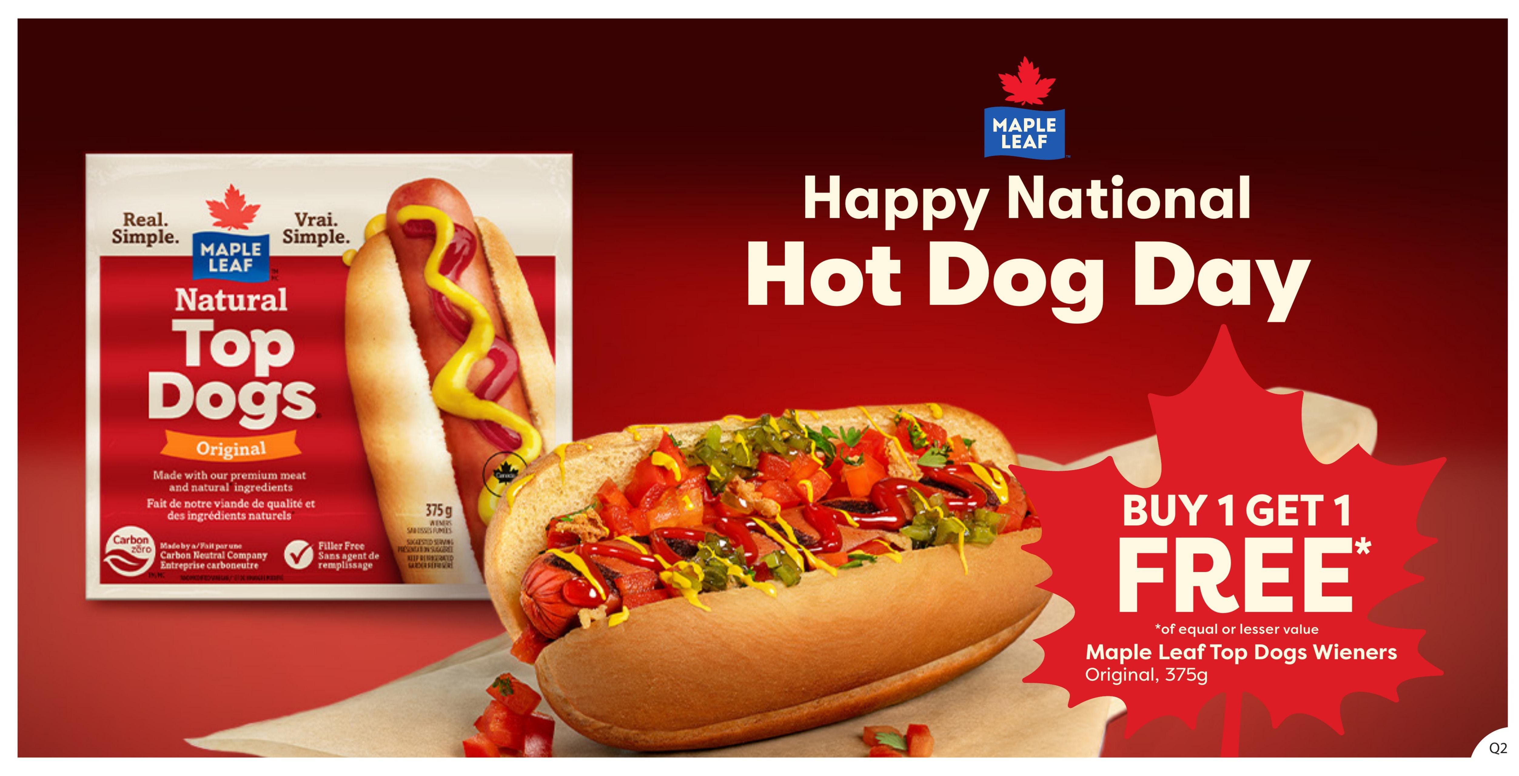 Quality Foods flyer page 5 features a 'Happy National Hot Dog Day' promotion. The main offer is Buy 1 Get 1 Free on Maple Leaf Top Dogs Wieners, Original, 357g, of equal or lesser value. The page showcases a package of Maple Leaf Natural Top Dogs Original, made with premium meat and natural ingredients, and a delicious-looking hot dog topped with relish, onions, and sauces.