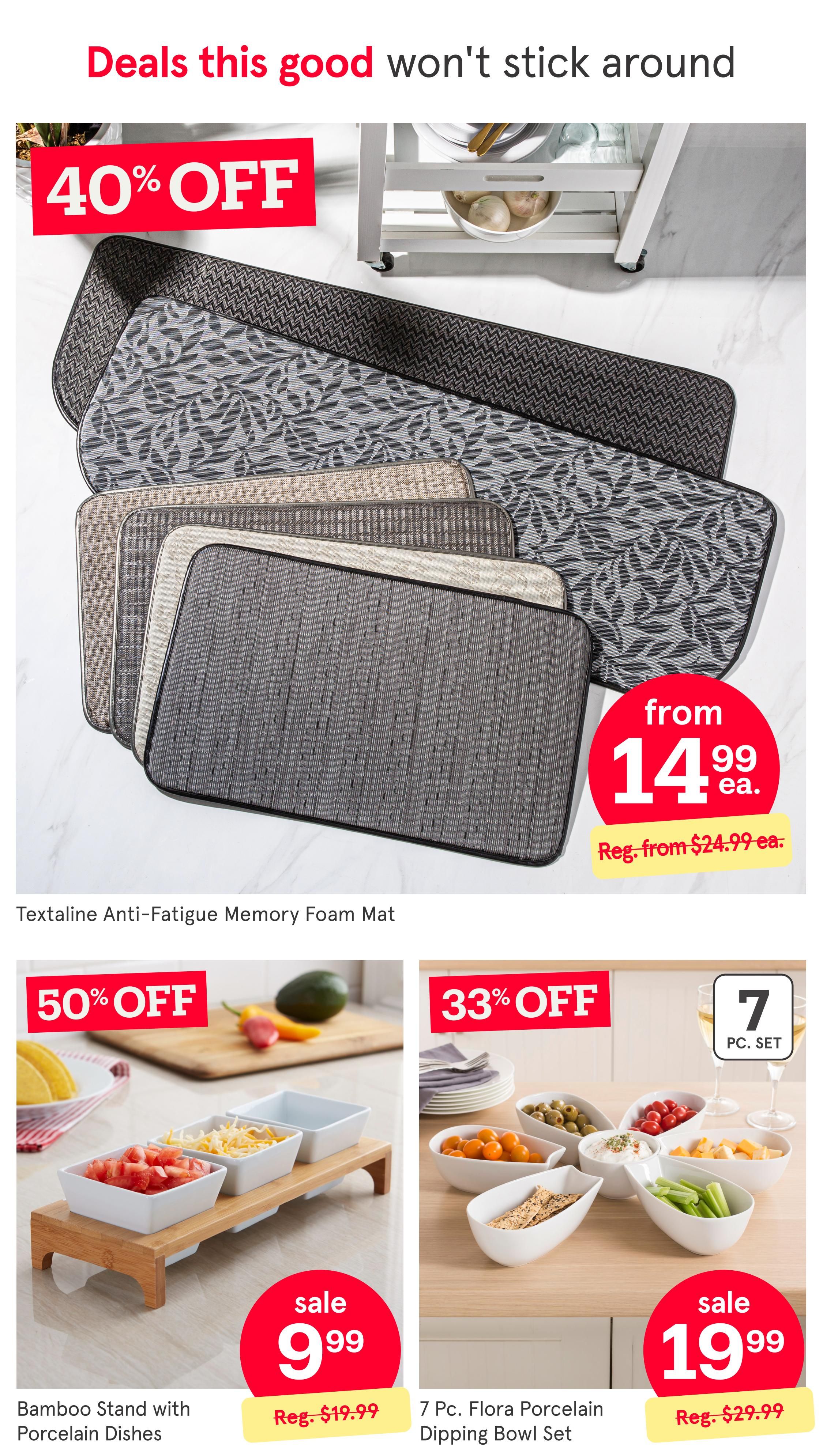 Kitchen Stuff Plus weekly flyer specials page 2 features deals on kitchenware. A large display shows Textaline Anti-Fatigue Memory Foam Mats on sale for $14.99 each, down from a regular price of $24.99, with a 40% off promotion. Below, a Bamboo Stand with Porcelain Dishes is on sale for $9.99, a 50% discount from its regular price of $19.99. To the right, a 7 Pc. Flora Porcelain Dipping Bowl Set is available for $19.99, marked down from $29.99, representing a 33% discount.
