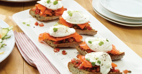Poached egg on toast with herbed tomatoes and smoked salmon