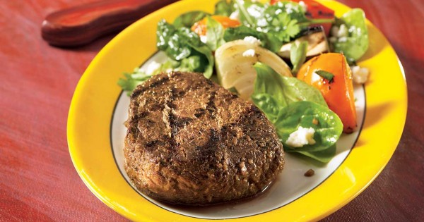 Pesto and garlic blossom venison medallions with grilled vegetable and feta salad